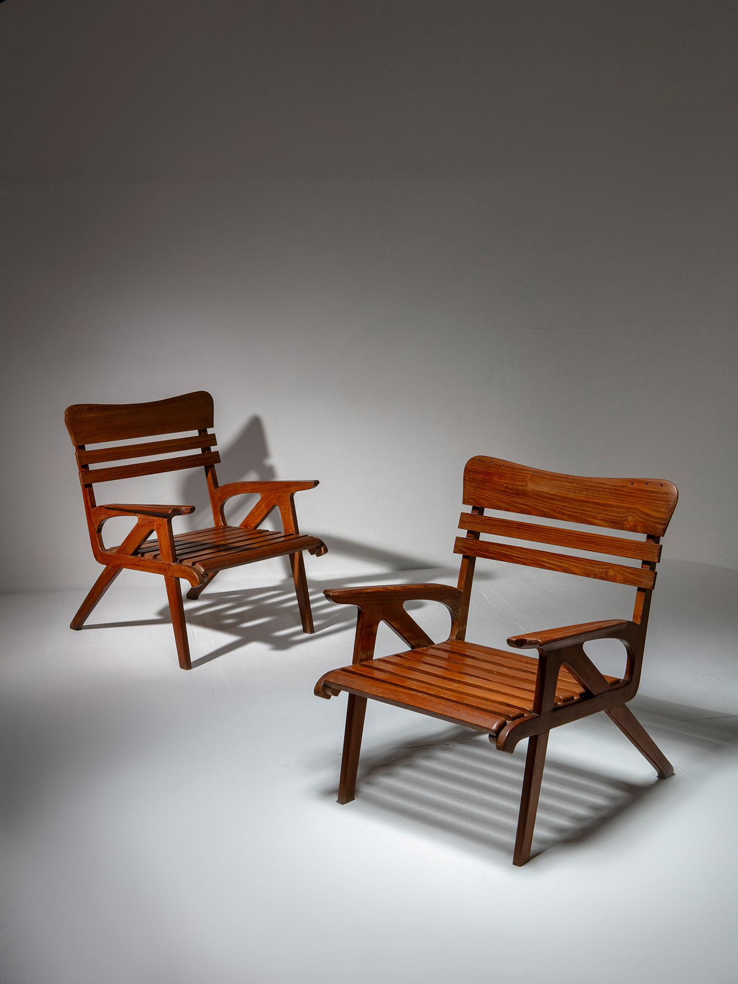 Pair of wood lounge chairs by Carlo Pagani.
Extremely detailed design with a nice patina.