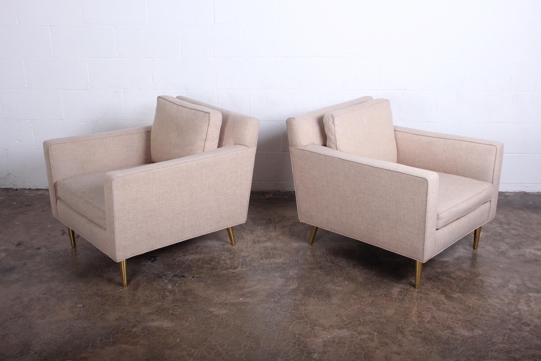A pair of 4872A lounge chairs with brass legs. Designed in 1948 by Edward Wormley for Dunbar.