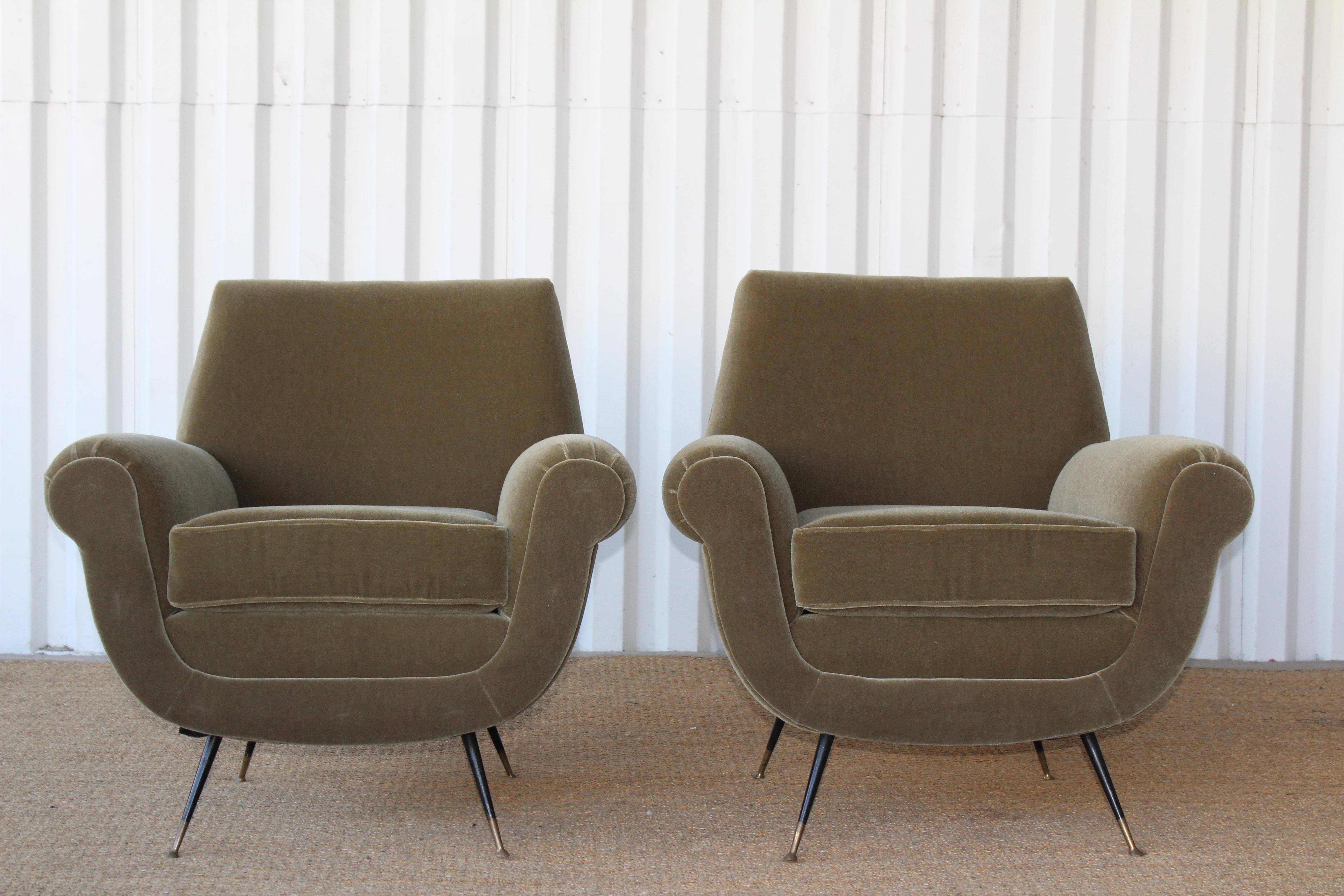 Pair of vintage 1950s Italian lounge chairs designed by Gigi Radice for Minotti. The pair have been restored and reupholstered in an olive green Italian wool mohair fabric. The legs are solid brass and retain their patina. Sold as a pair.