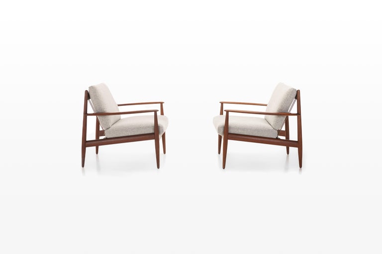Beautiful set of two armchairs in teak designed by Grete Jalk for France & Daverkosen in 1962. The easy chairs are reupholstered and marked by the producer.