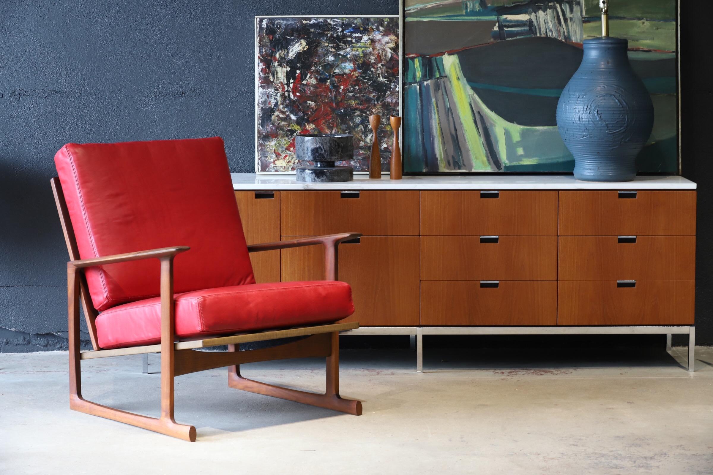 Absolutely luscious pair of lounge chairs designed by Ib Kofod-Larsen for Selig in red Italian leather. Both retaining Made in Denmark badge. Pictured with Florence Knoll credenza and Eames LTR for scale.