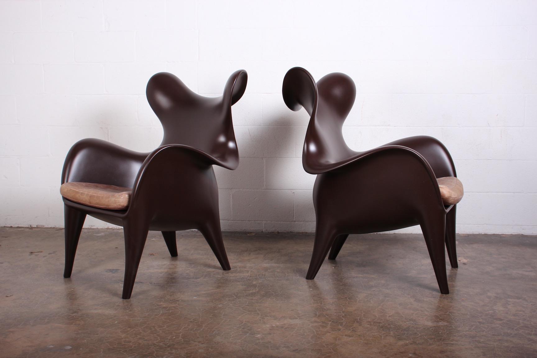 A pair of sculptural lounge chairs designed by Jordan Mozer for the Américas Restaurant in Houston, TX. These have been restored and color-matched to the original flat chocolate brown lacquer. The original leather cushions have a wonderful patina.