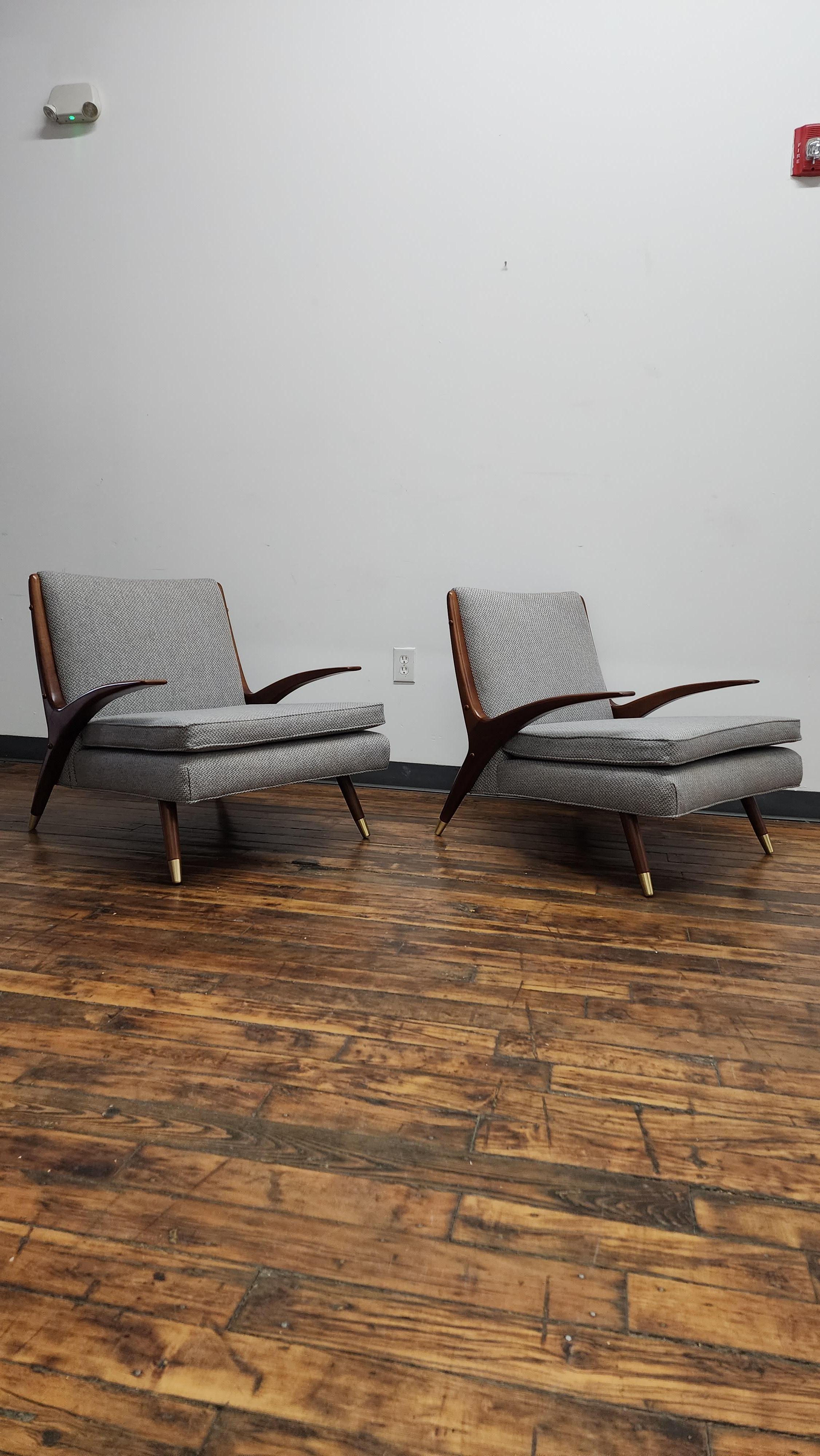 A pair of walnut lounge chairs with brass sabots by Karpen of California, 1950's. Restored and reupholstered in a grey fabric. back cushion is also available but not necessary. (last photo)
