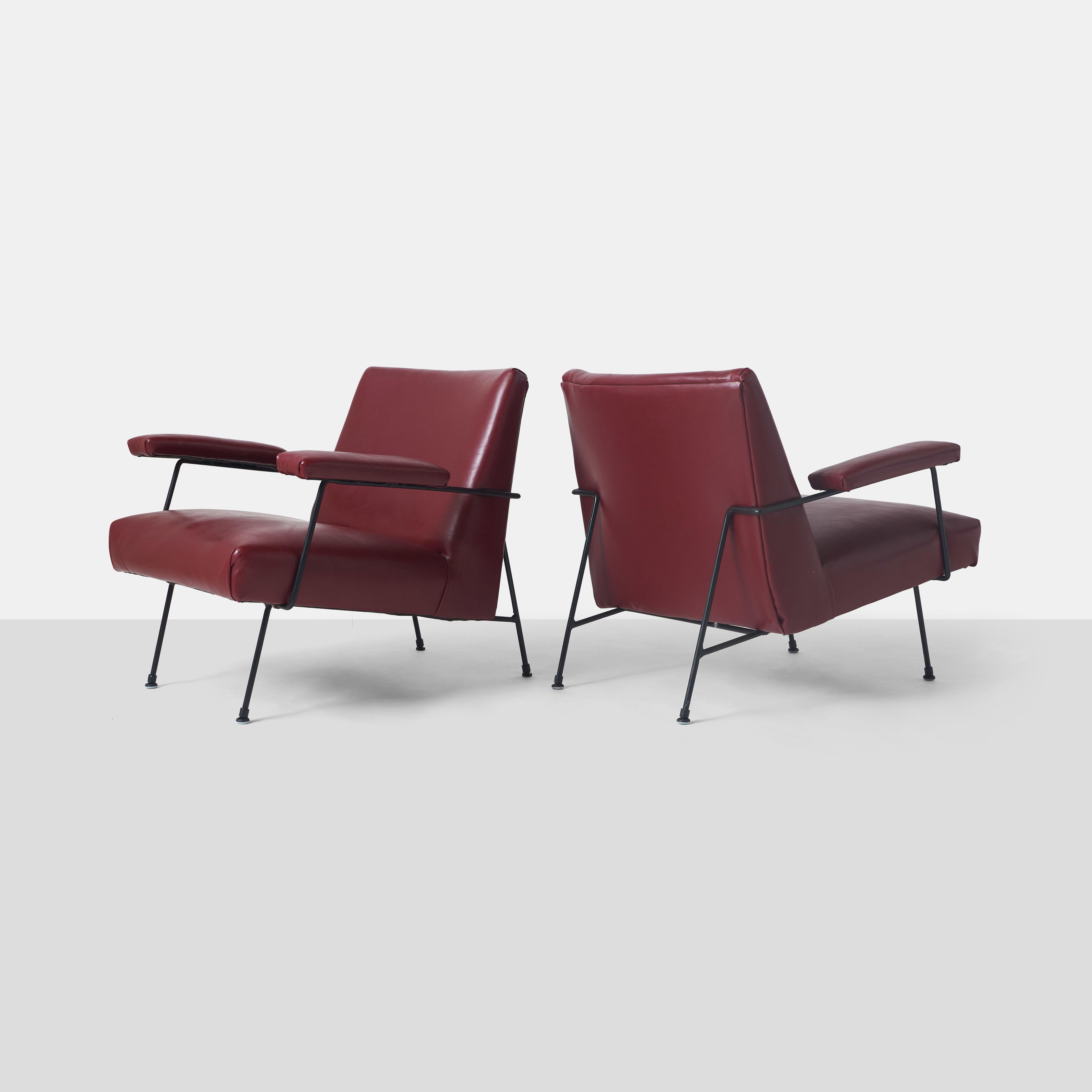 A pair of rare lounge chairs by Milo Baughman. Features a black iron frame. Manufactured by Pacific Iron Products 1950.

The frames have been repainted at some point. While the red faux leather upholstery is in fair condition, the chairs would