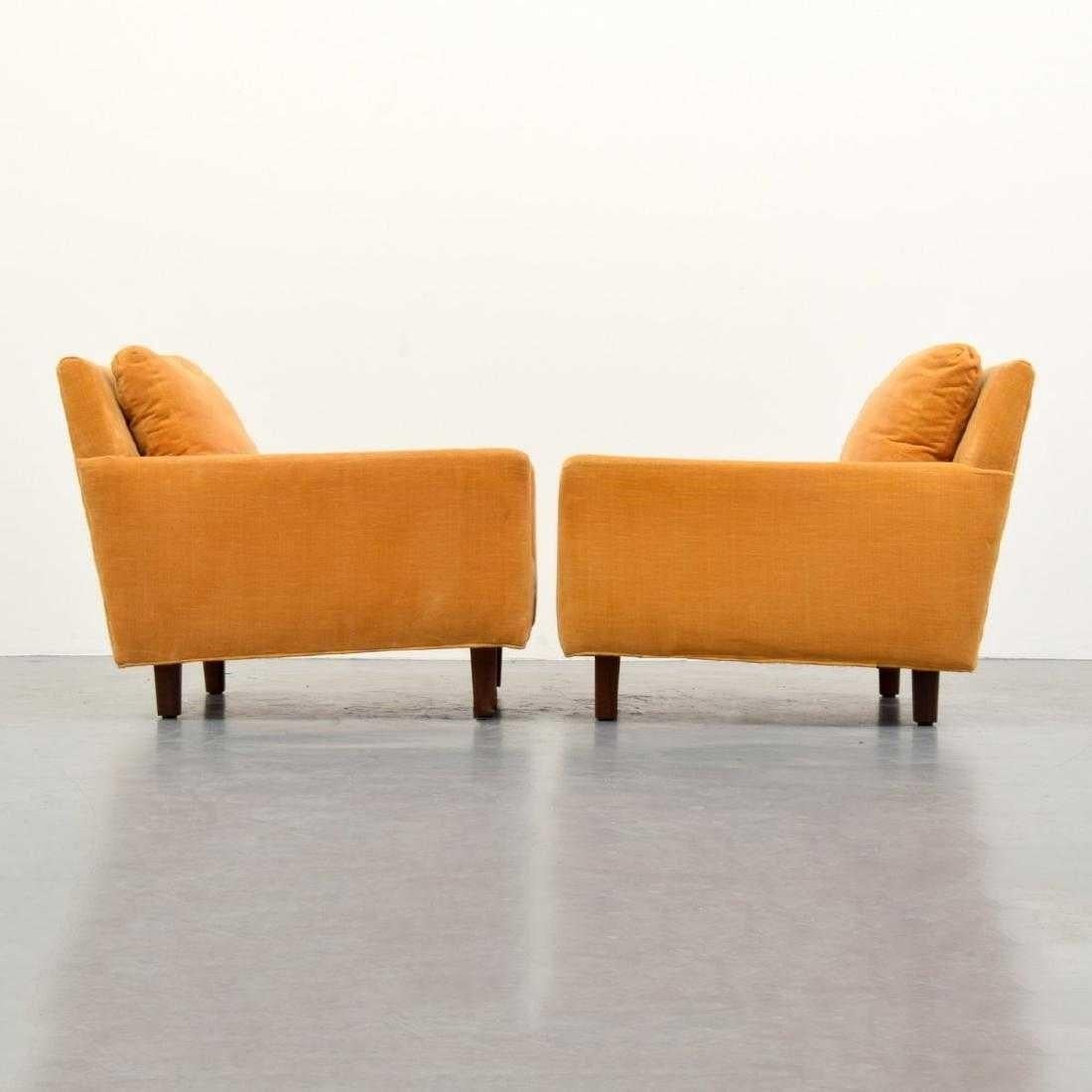 This comfortable pair of midcentury lounge chairs designed by Milo Baughman for Thayer Coggin. Professionally upholstered with orange/yellow colored velvet fabric with solid wood feet.