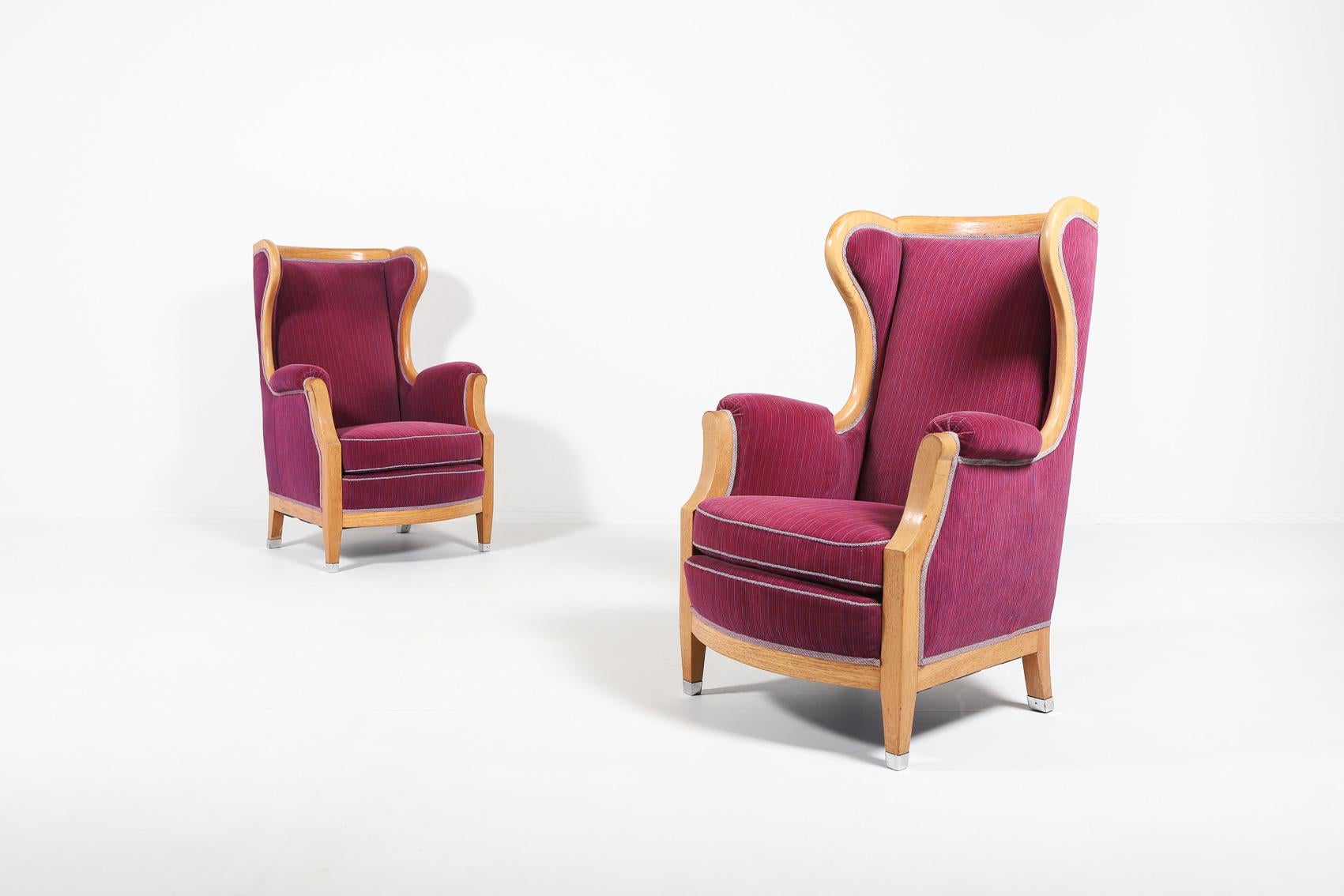 Pair of 2 spectacular lounge armchairs with varnished oak frame and pink purple striped fabric upholstery, loose sitting cushions. The mastery of Swedish architect Oscar Nilsson, aristocratic and sleek at the same time.

Priced for a
