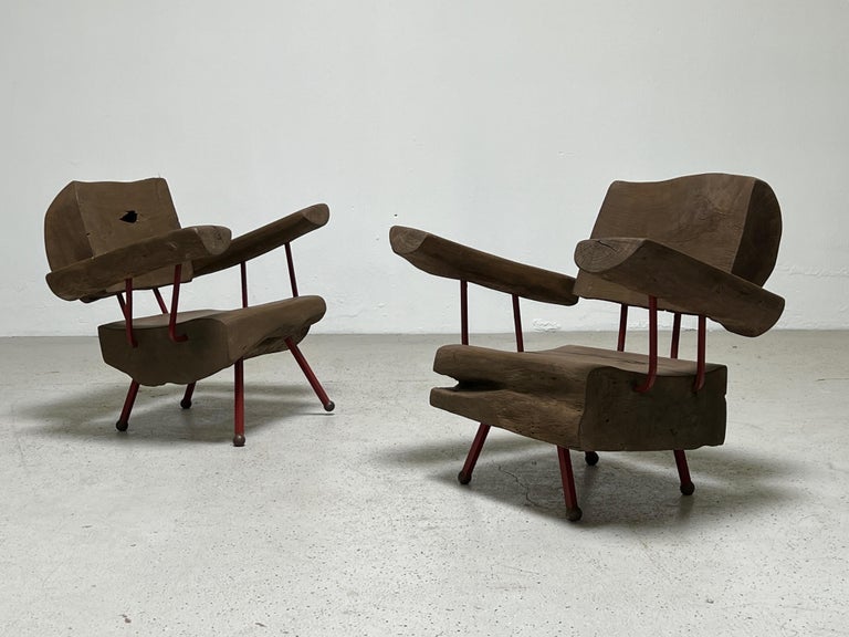 A pair of hefty solid wood lounge chairs with iron frames by Sabena of Mexico.