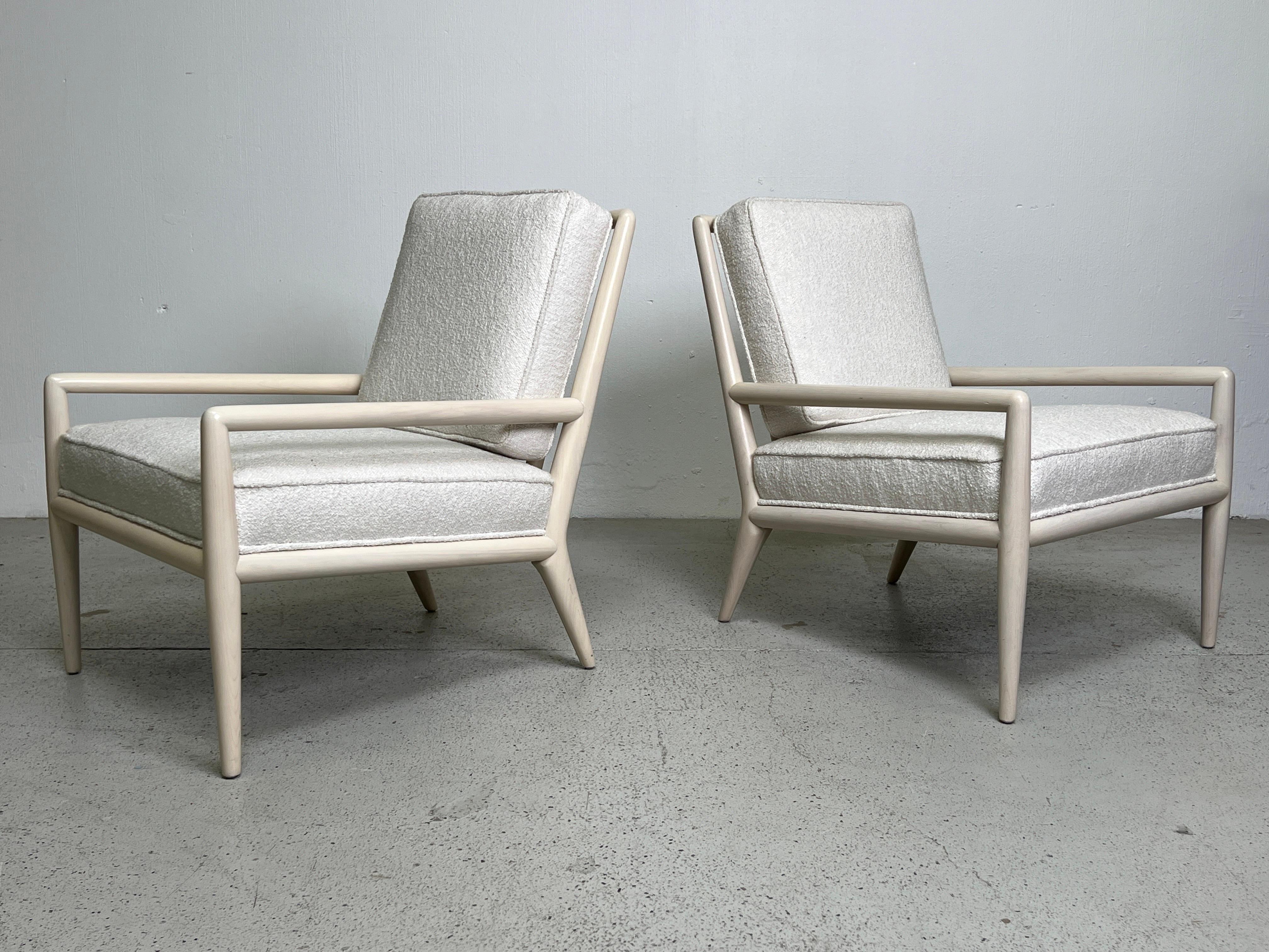 A pair of walnut lounge chairs with whitewashed frames designed by T.H. Robsjohn-Gibbings for Widdicomb. 