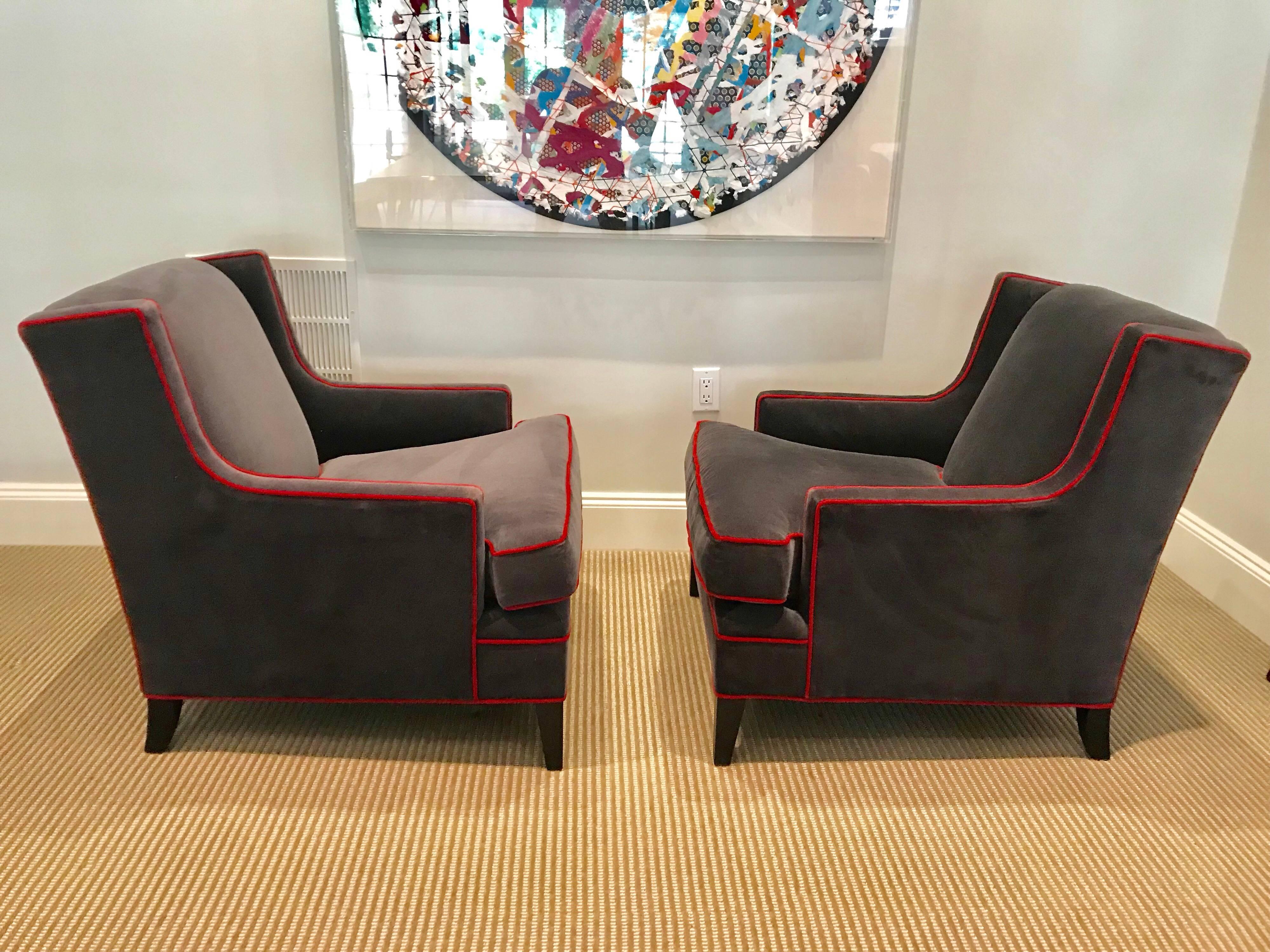 This comfortable pair of Mitchell Gold & Bob Williams Lolling chairs are covered in grey cotton velvet with a contrasting red gimp. They came from a fine local home without pets and were barely used. There is also a 7' long sofa that is listed