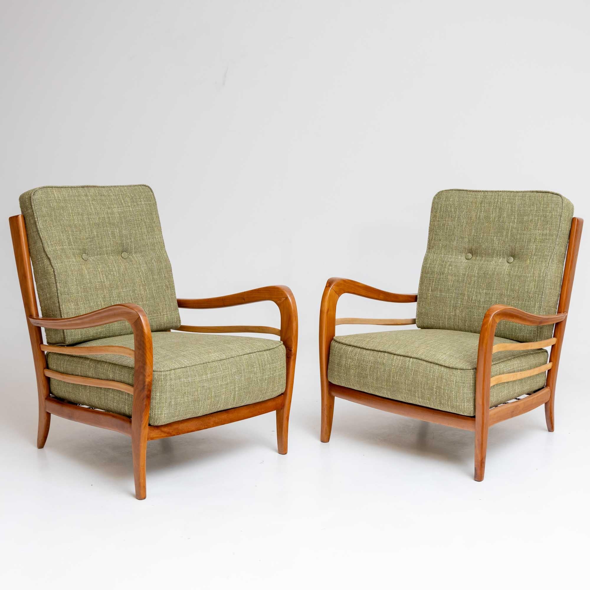 Pair of light green upholstered lounge chairs, attributed to the Italian designer Paolo Buffa (Italy, 1903-1970). The elegant curved frames made of solid cherry have been polished and the seat cushions are newly upholstered. Like the sides, the back