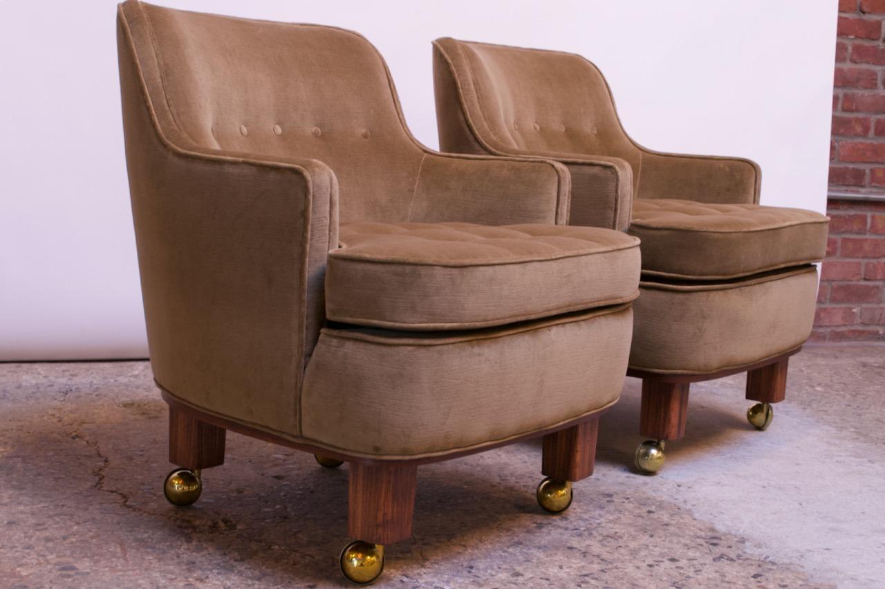 Pair of diminutive lounge chairs by Edward Wormley for Dunbar, (circa 1947, USA). Pair includes brass caster wheels, which can easily be added or removed for better stability, as shown. Seat and back feature a button-tufted detail (mirroring that of