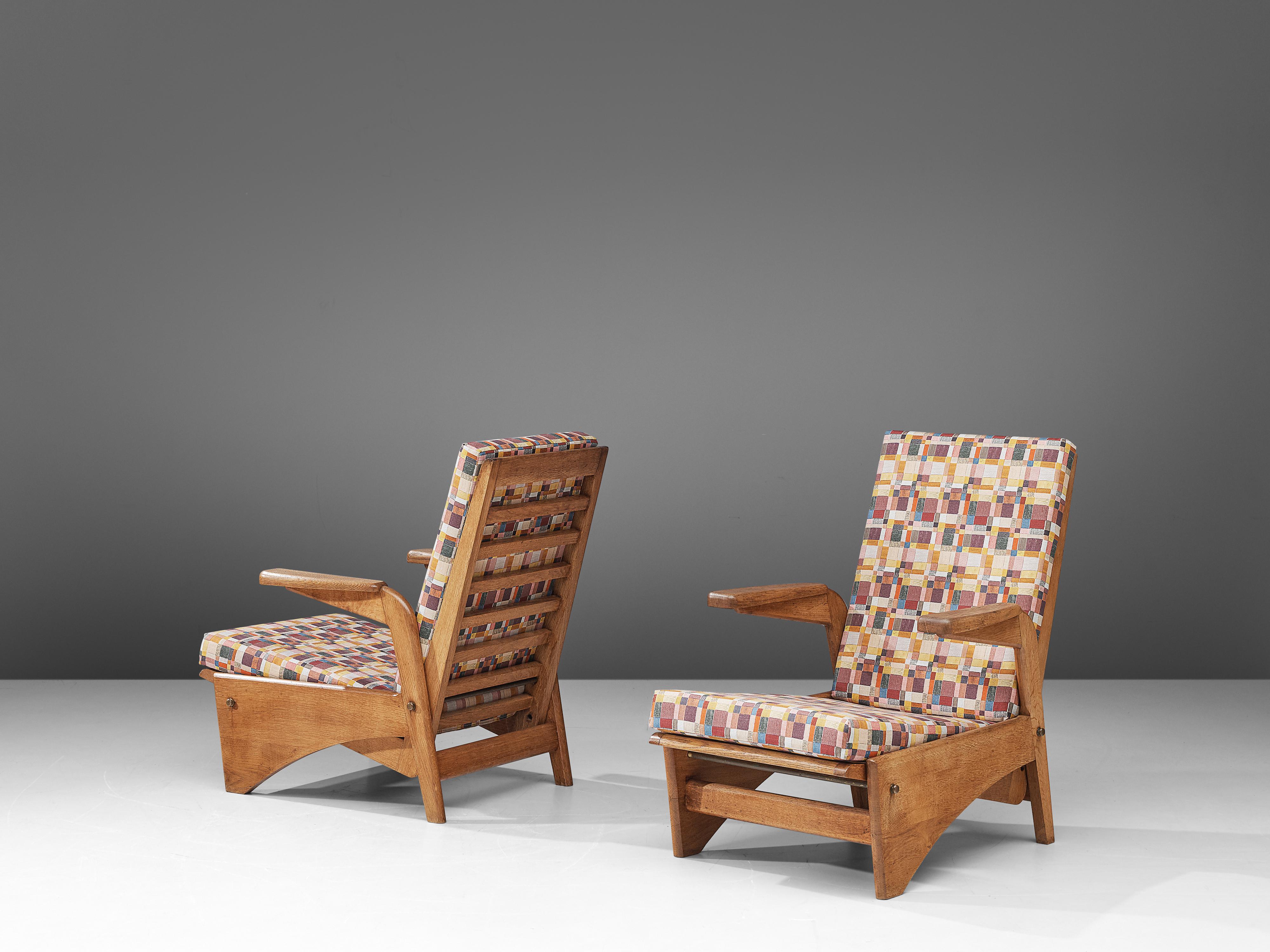 Gustave Gautier, pair of lounge chairs, oak, fabric, France, 1954.

This sculptural set of easy chairs by Gustave Gautier is very well executed and made out of solid oak. The slatted backrest and seat are adjustable to make it a comfortable lounger.