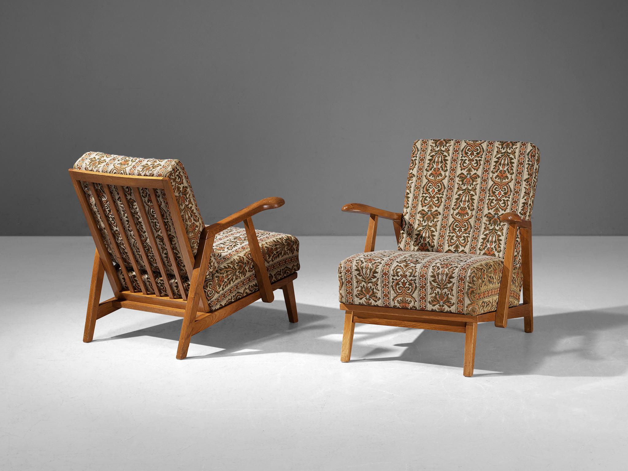 Pair of lounge chairs, oak, Czech Republic, 1950s

These beautifully designed lounge chairs hold a striking construction by means of the sculpted elements discernible in the wooden frame. The armrests are characterized by curved, strong lines with