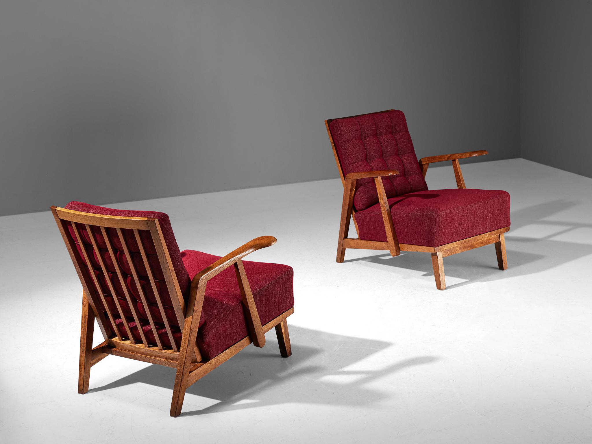 Pair of lounge chairs, oak, fabric, Czech Republic, 1950s

These beautifully designed lounge chairs hold a striking construction by means of the sculpted elements discernible in the wooden frame. The armrests are characterized by curved, strong