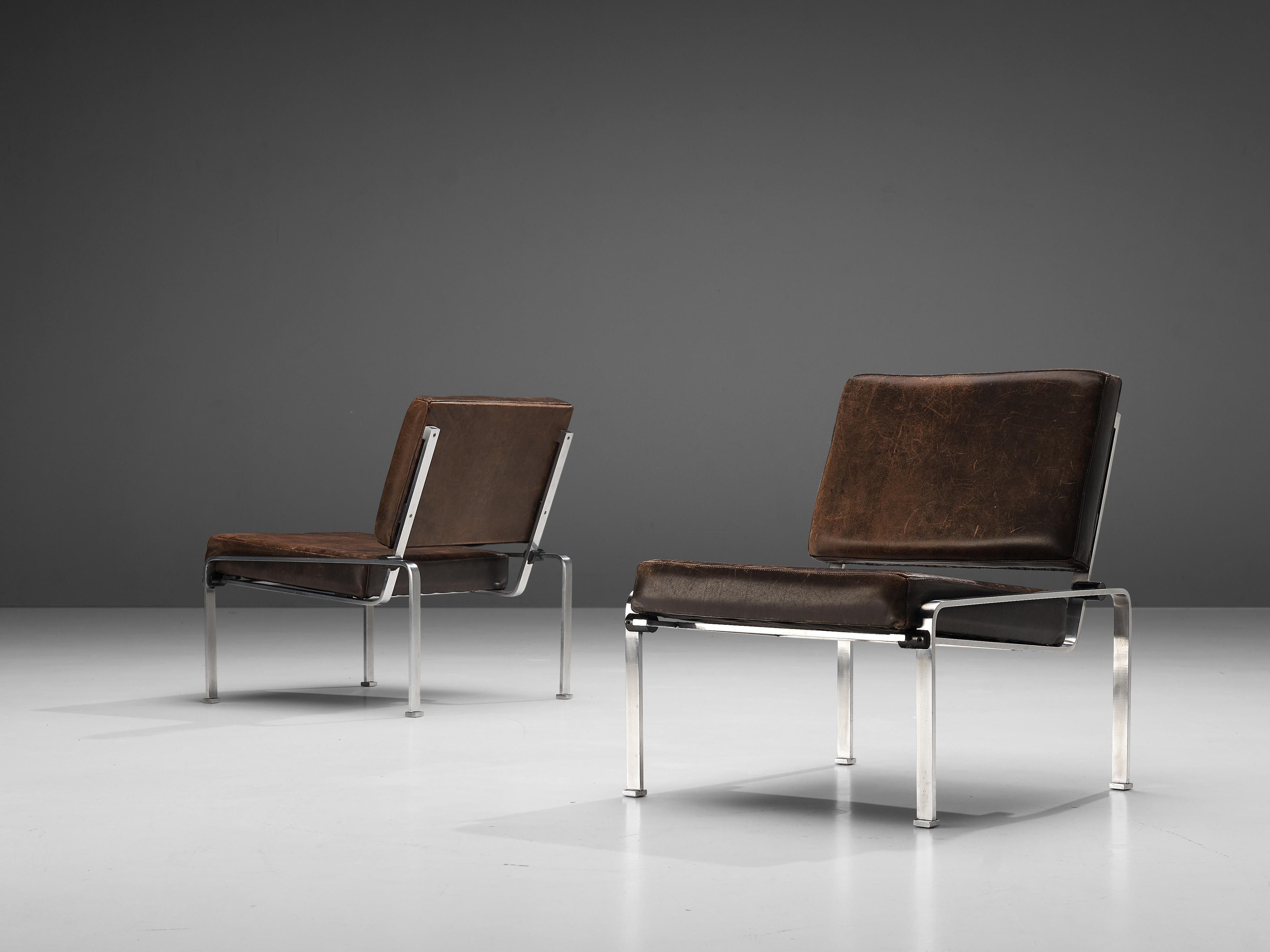 Lounge chairs, leather, chromed metal, Europe, 1960s

The striking patina on the brown leather of these lounge chairs combines wonderful with the chromed frame. Due to the thin frame and the honest, open construction the chairs have an airy look