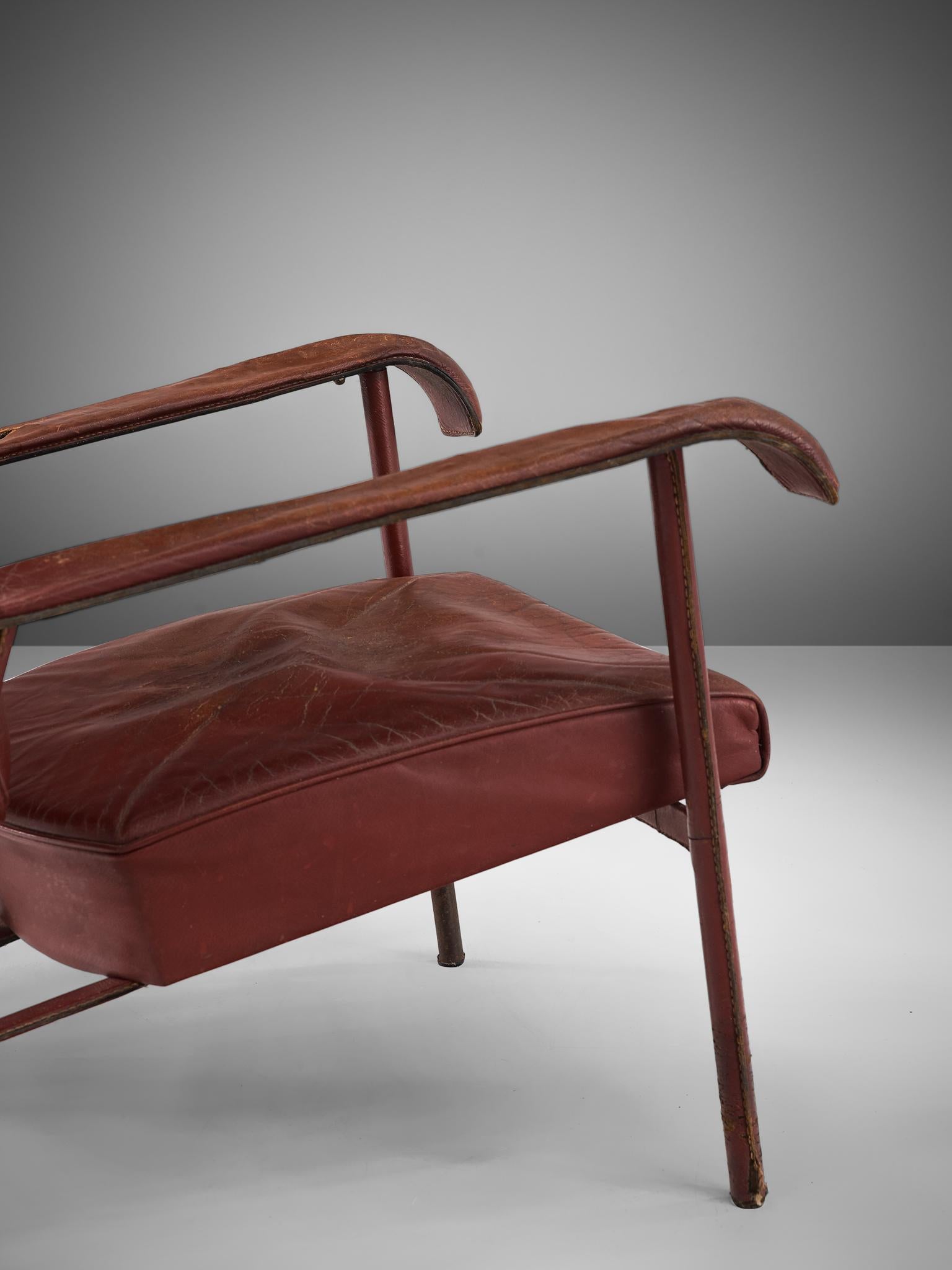 Metal Pair of Lounge Chairs in Patinated Burgundy Leather by Jacques Adnet
