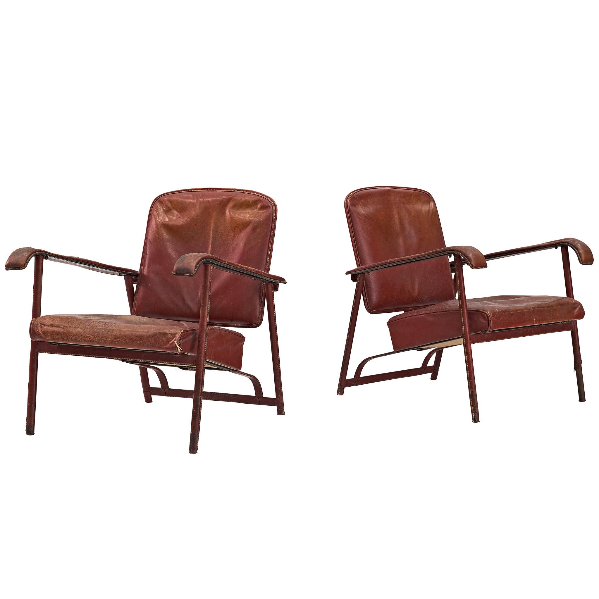 Pair of Lounge Chairs in Patinated Burgundy Leather by Jacques Adnet