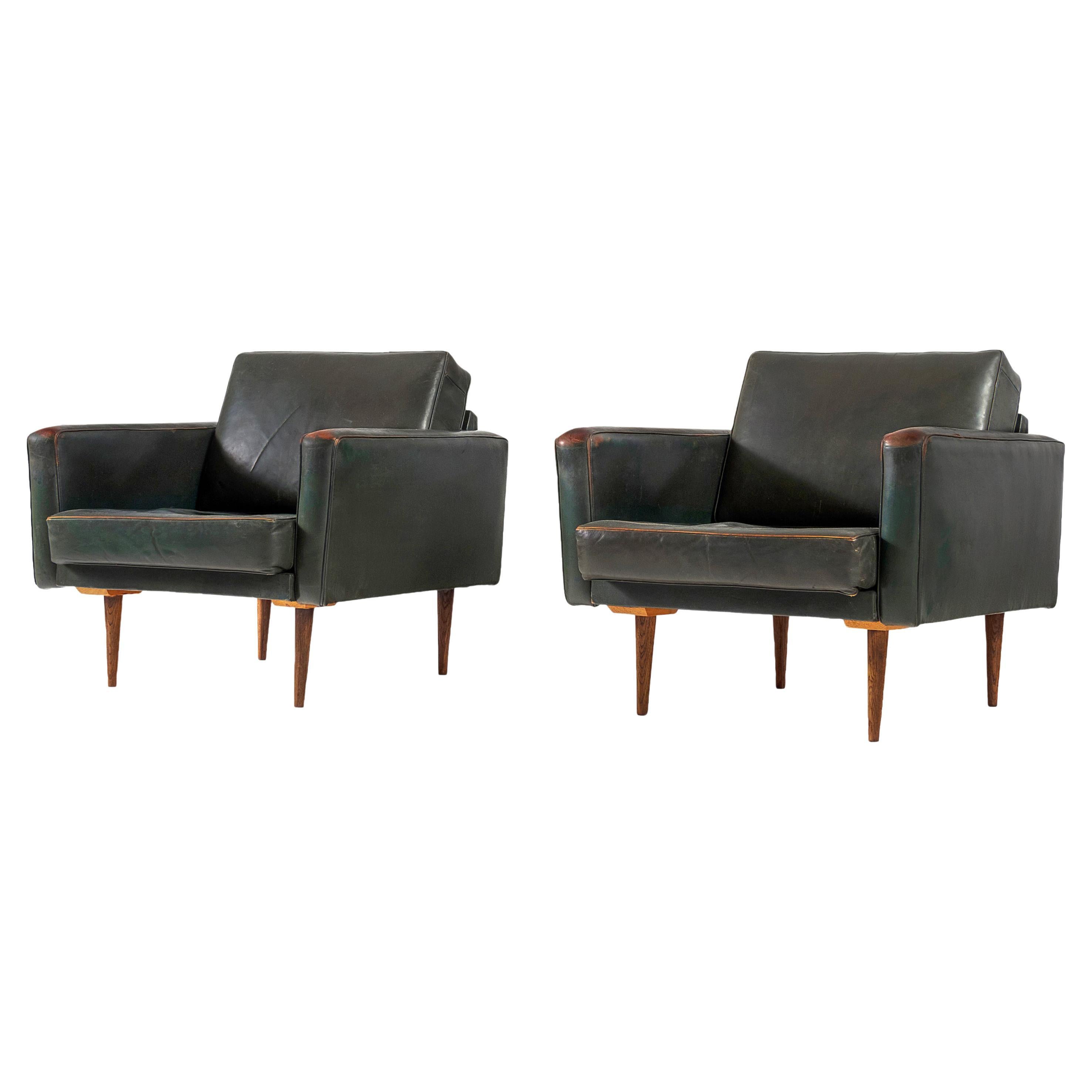Pair of Lounge Chairs in Patinated Dark Green Leather