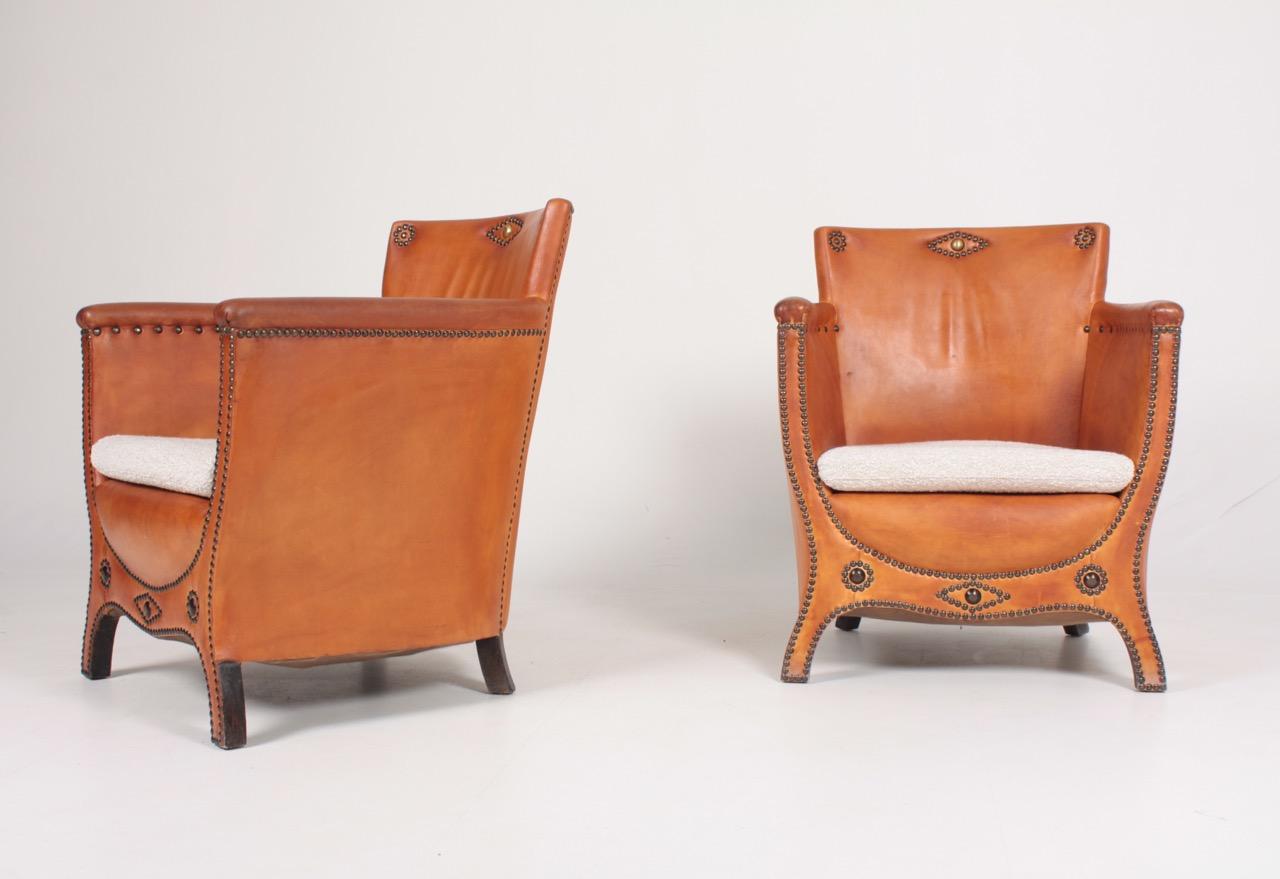 Pair of lounge chairs in leather and boucle. Designed by Otto Schulz and made by Boet AB. Great condition.