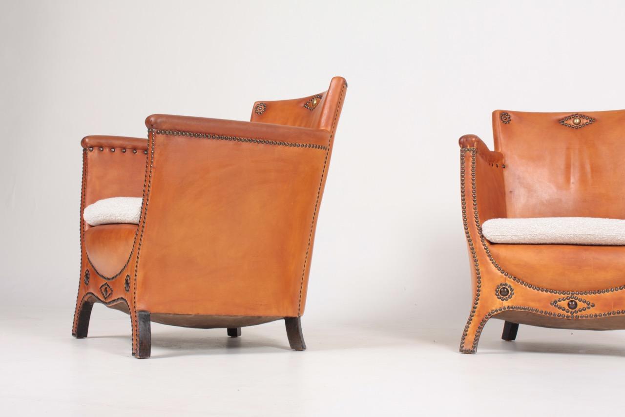 Swedish Pair of Lounge Chairs in Patinated Leather and Boucle Designed by Otto Schulz