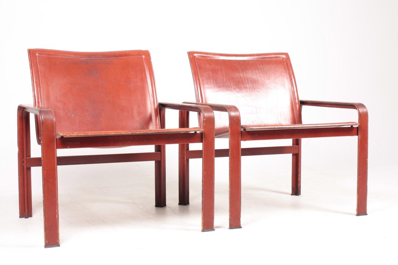 Pair of lounge chairs in patinated leather. Designed and made by Matteo Grassi in Italy in the 1970s. Great original condition.