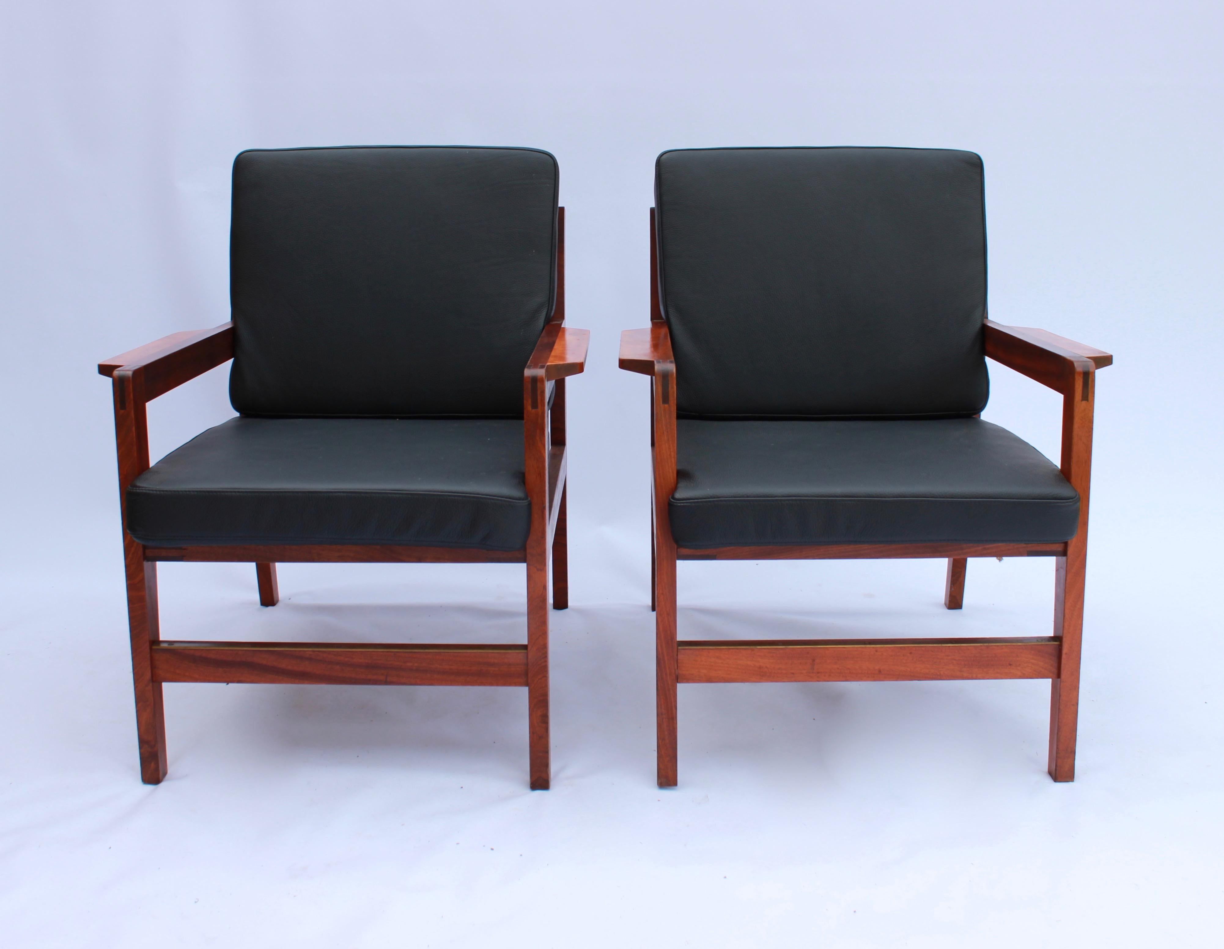 Ein Paar Loungesessel aus poliertem Holz und schwarzem Classic-Leder mit dänischem Design aus den 1960er Jahren. Die Stühle sind in hervorragendem Vintage-Zustand.