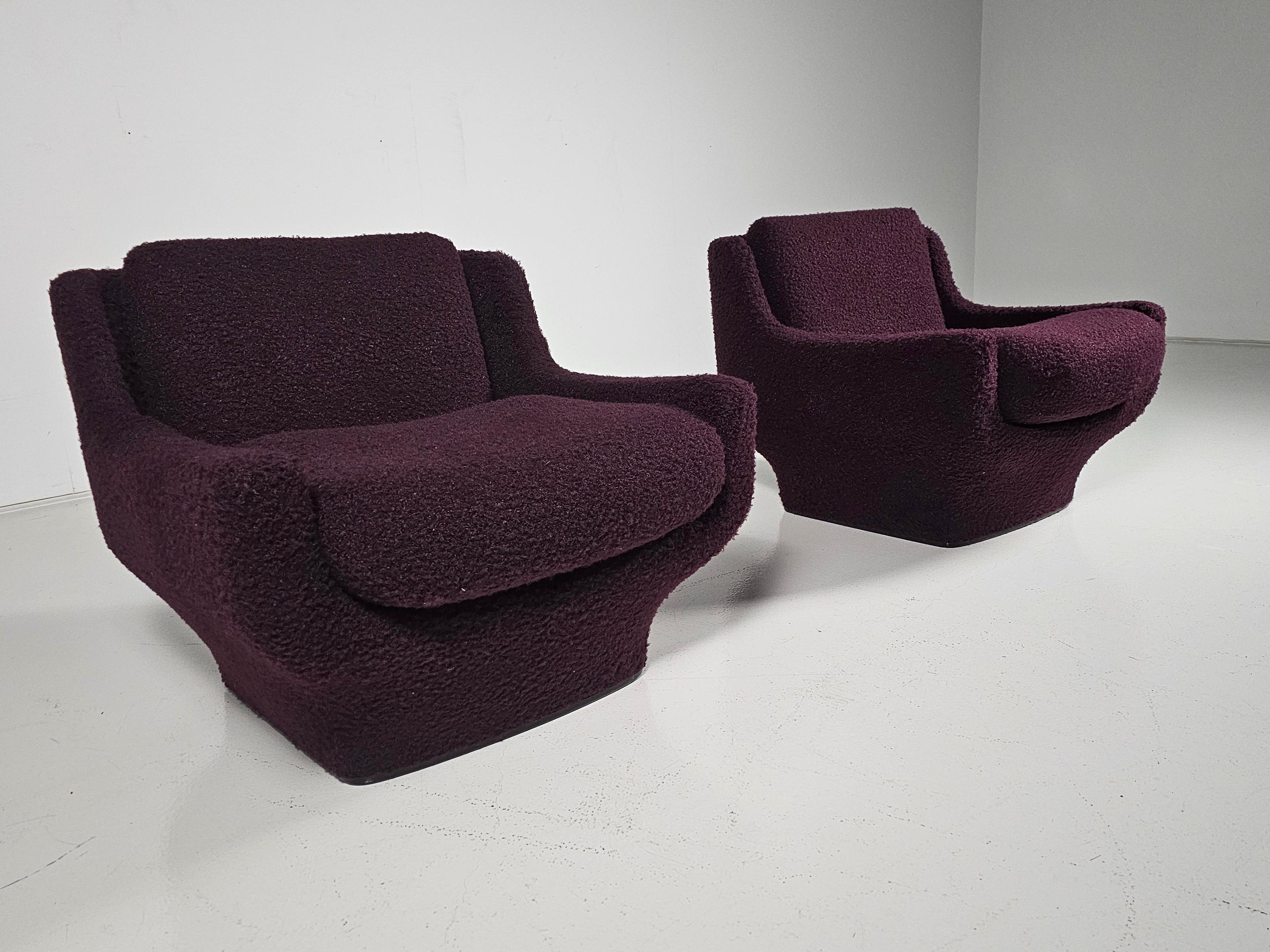 Very comfortable space age lounge chairs manufactured by Airborne during the 70's.  

Its organically rounded and embracing form invites for a comfortable sitting. This version is fully upholstered in a dark purple boucle fabric. 

Super lightweight