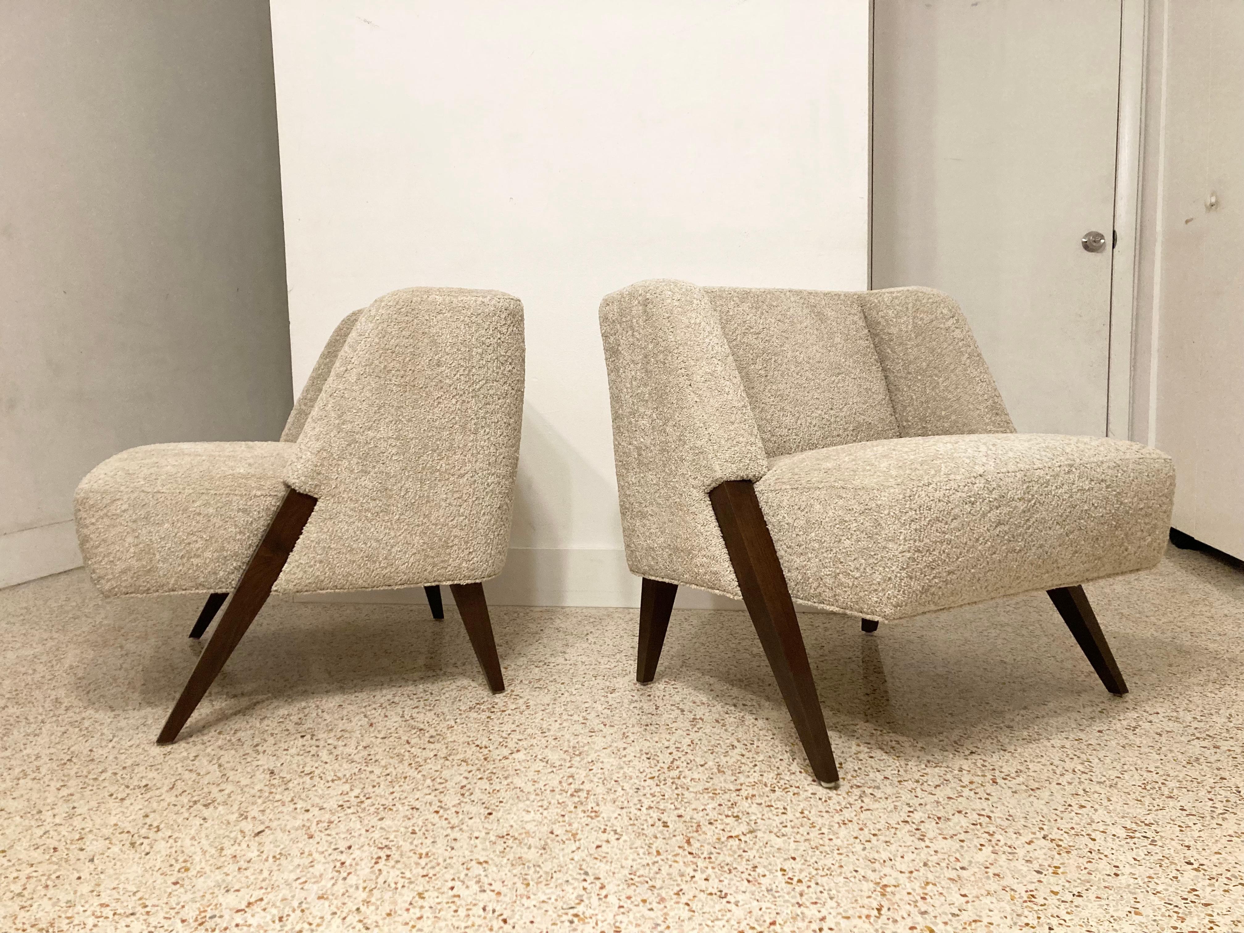 Incredible pair of lounge chairs in the style of Gio Ponti. Solid walnut legs and sand colored bouclé fabric. Ready for a new home.
