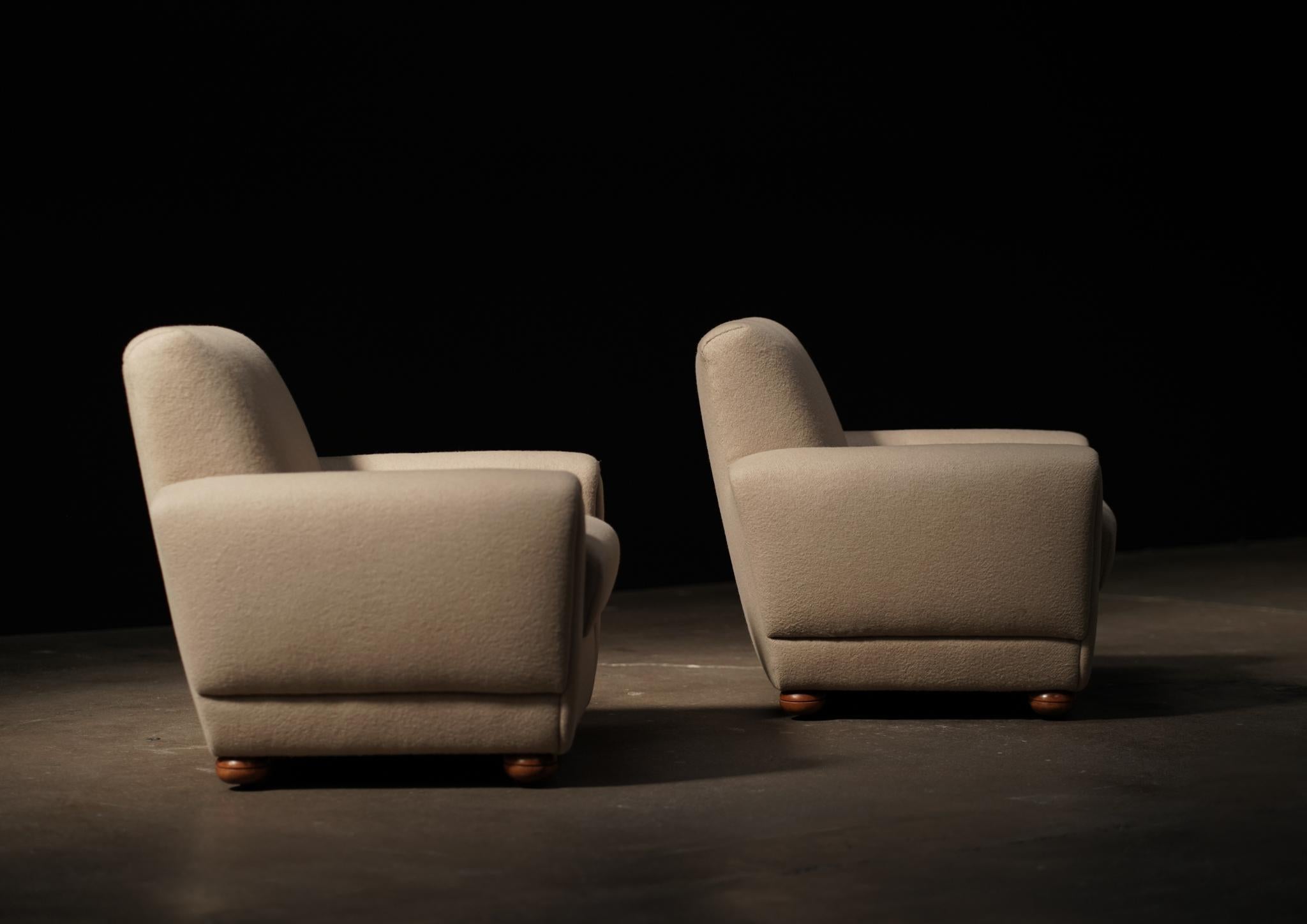 Dieses Paar dänischer Loungesessel steht auf eleganten Füßen und wurde vor kurzem mit weicher, strukturierter Wolle gepolstert, was seine skulpturale Form unterstreicht. Warm und einladend bringen sie einen zeitlosen Charme in jedes Interieur.