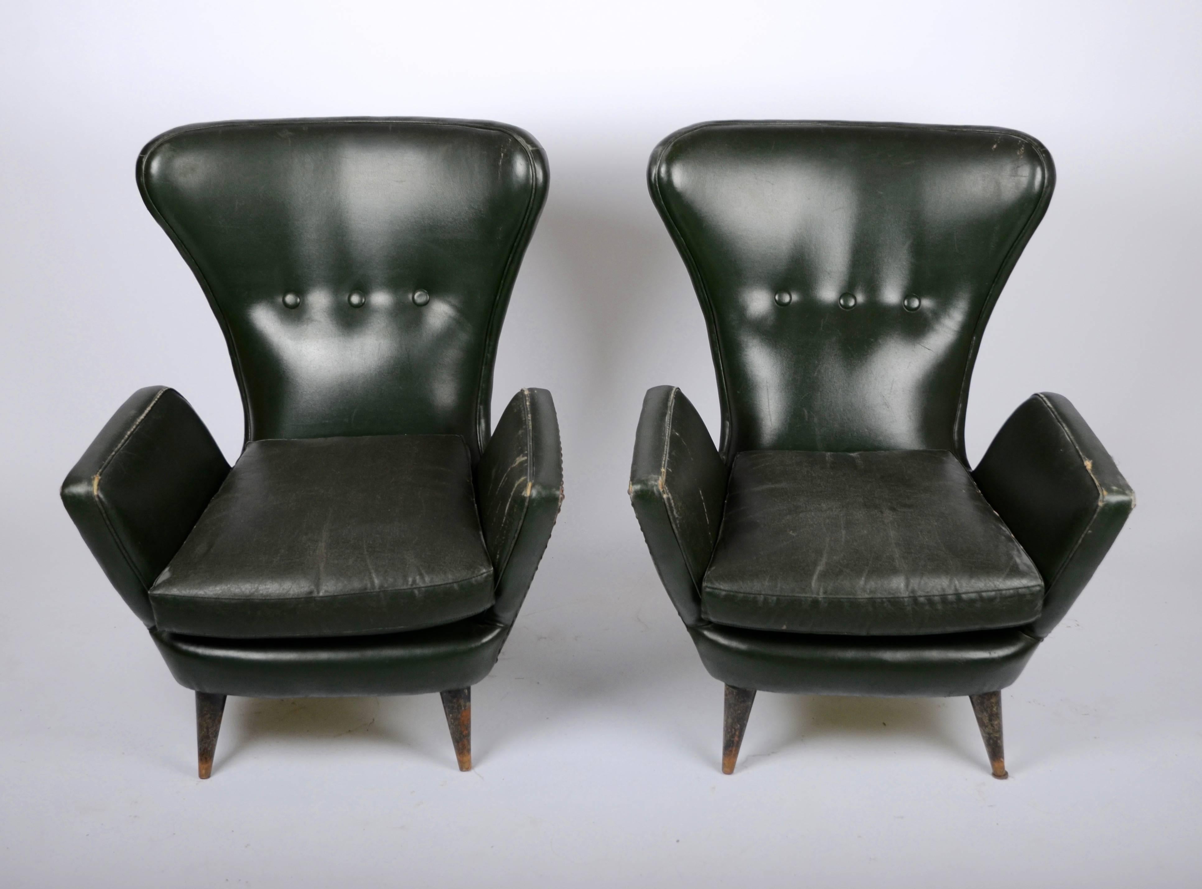 A pair of lounge chairs, in vinyl, Italian, 1950s. In need of reupholstering.