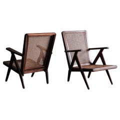 Pair of lounge chairs made out of wood and canning, France 1950