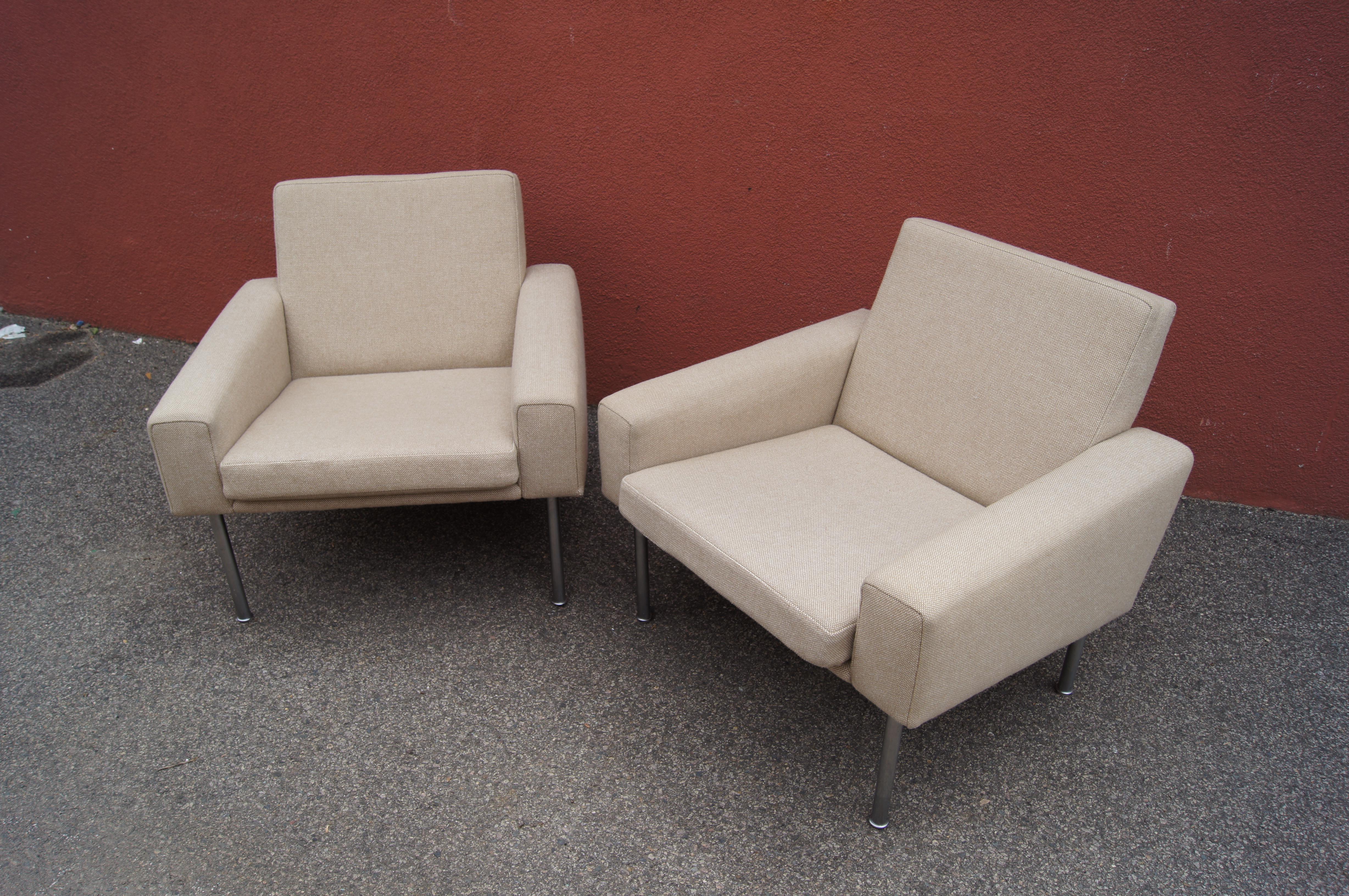 This pair of comfortable lounge chairs, model AP34/1, are part of a series that Hans Wegner designed for A.P. Stolen in 1957. Tubular legs of matte chrome-plated steel support a frame with dynamic lines, commodious seat, and wide armrests. The