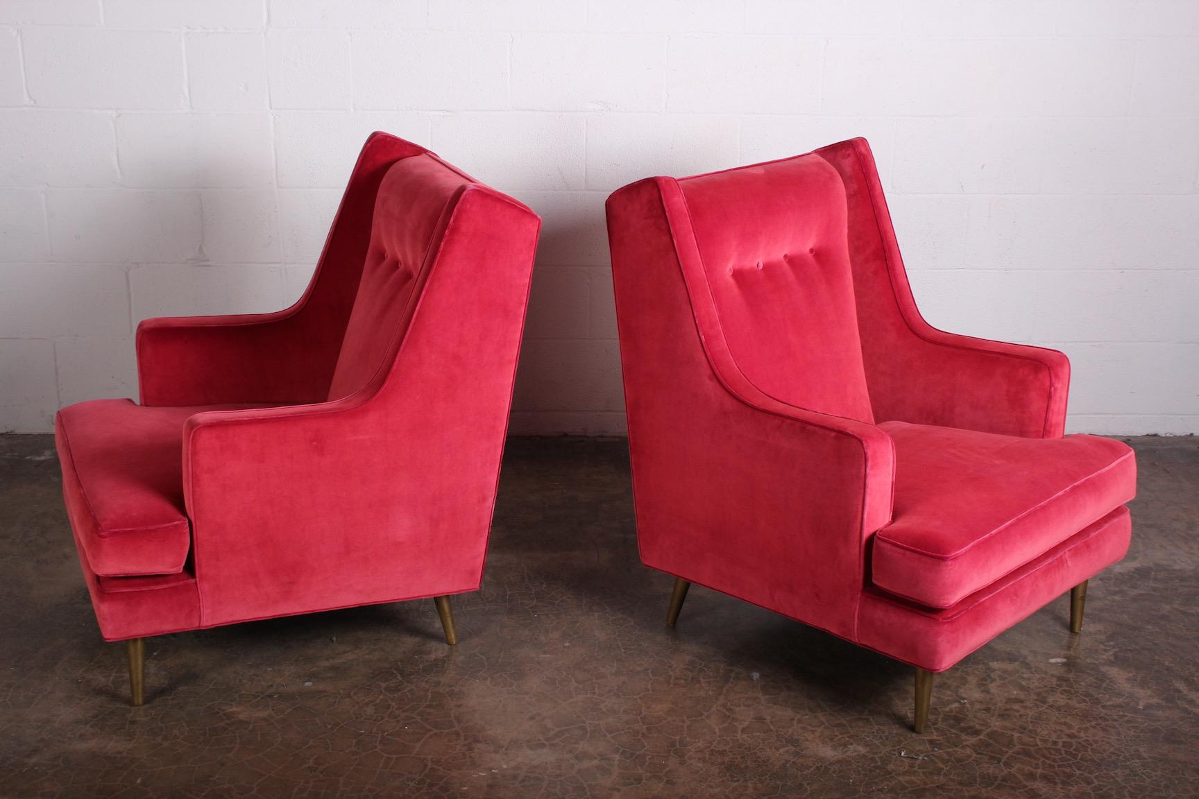 A classic pair of Dunbar high back lounge chair on brass legs. Designed by Edward Wormley. Upholstered in Rubelli velvet.