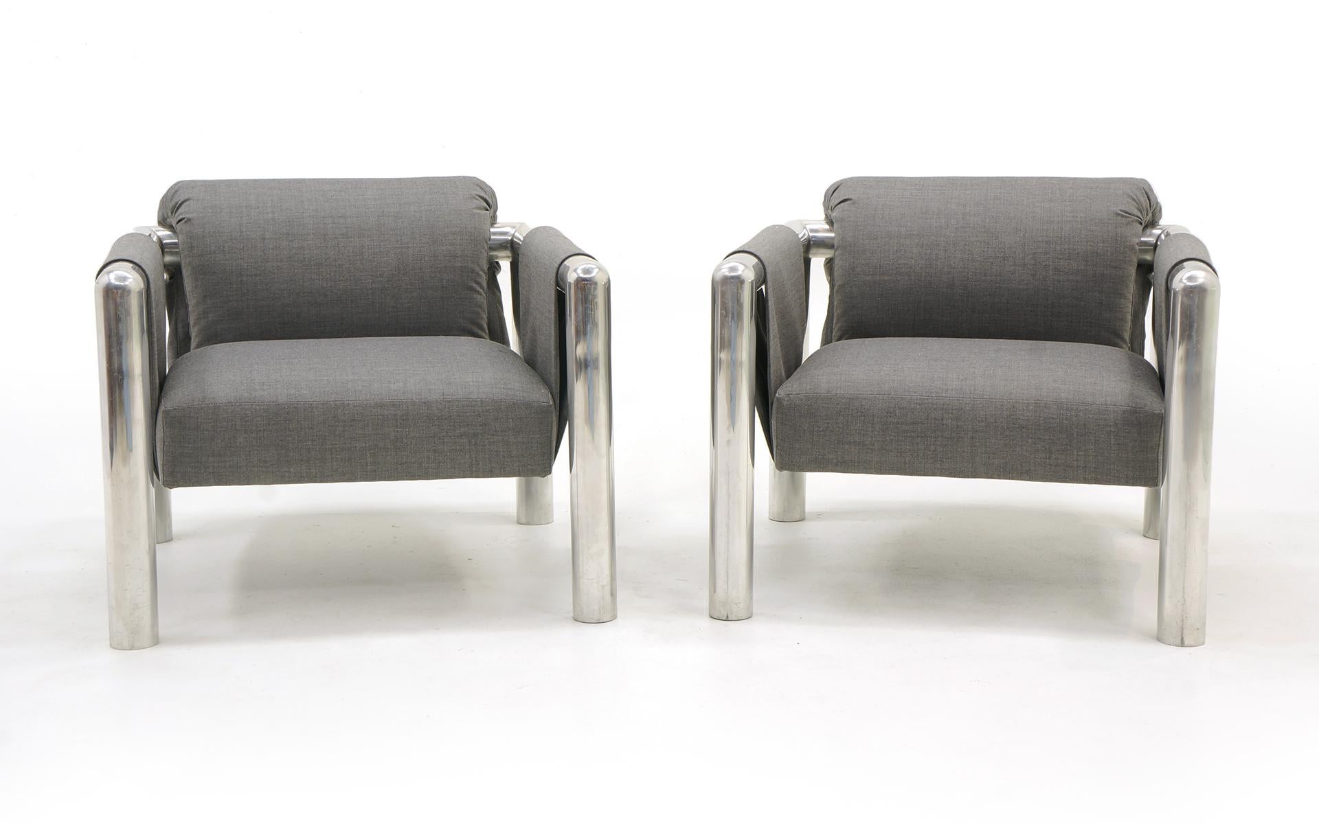 Pair of John Mascheroni lounge chairs. Large tubular aluminum frames and expertly reupholstered in a medium gray Maharam fabric.