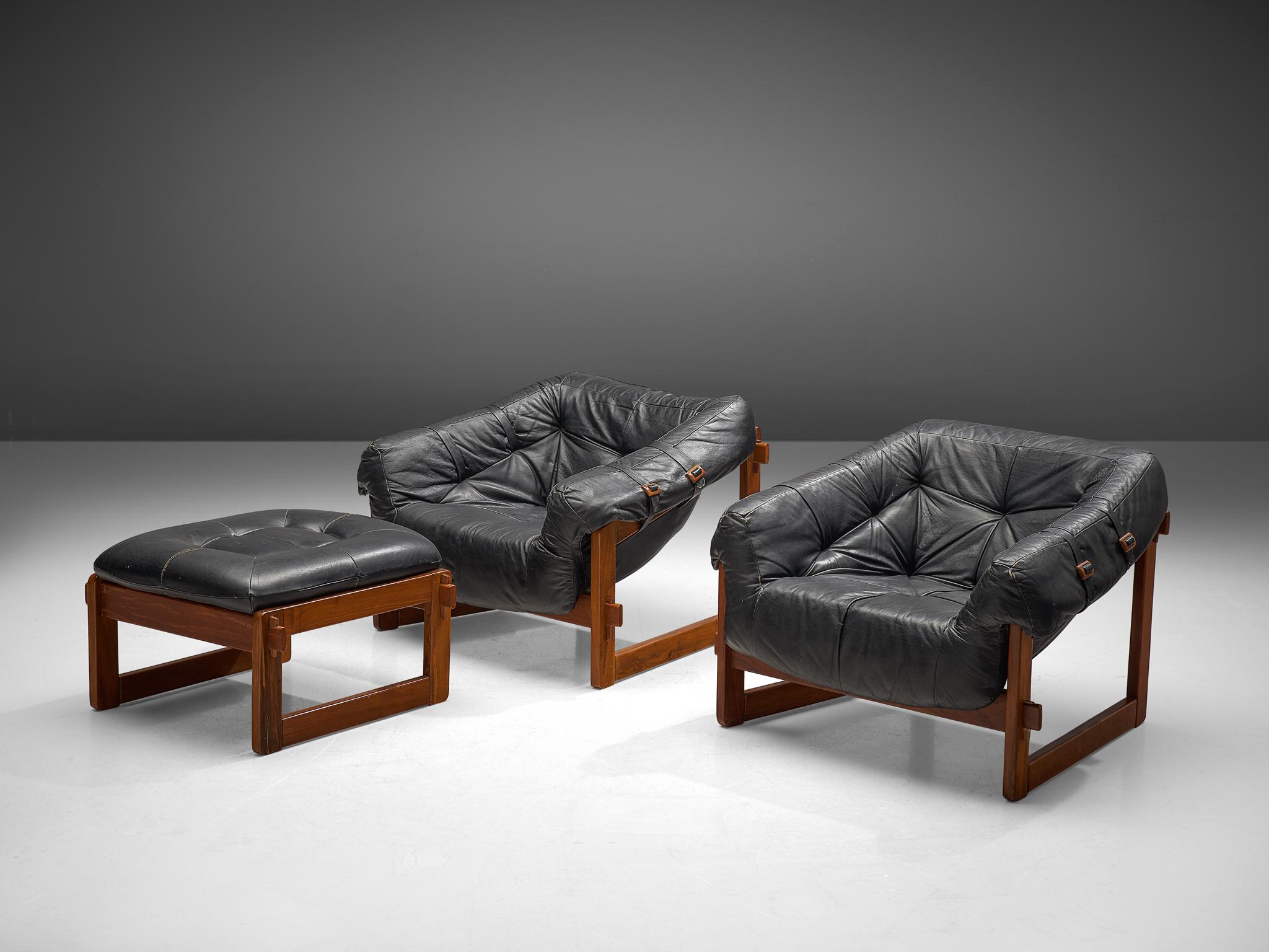 Percival Lafer, set of 2 lounge chairs with ottoman, leather and Brazilian hardwood, Brazil, late 1960s.

Bulky and grand lounge chairs with one stool by Brazilian designer Percival Lafer. This set features a solid dark wooden base with leather