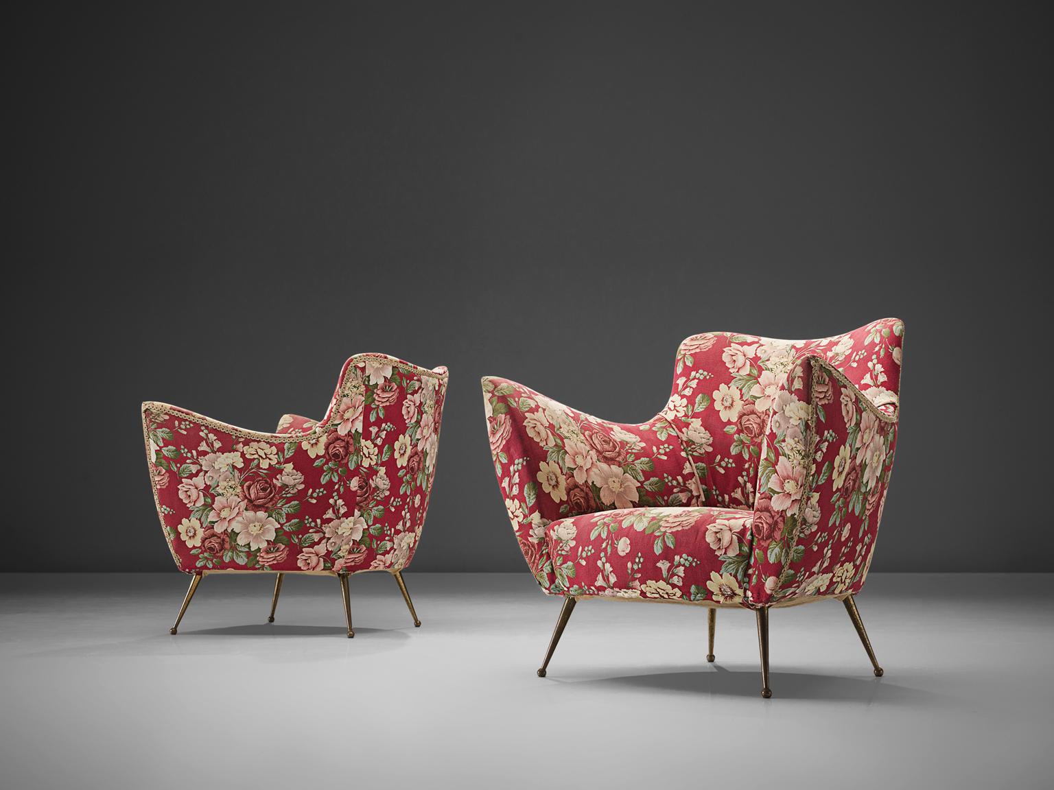 ISA Bergamo, lounge chairs in original floral pink and red fabric, brass, Italy, 1950s. 

These chairs are iconic examples of Italian design from the 1950s. Organic and sculptural, these easy chairs are anything but minimalistic. Equipped with the