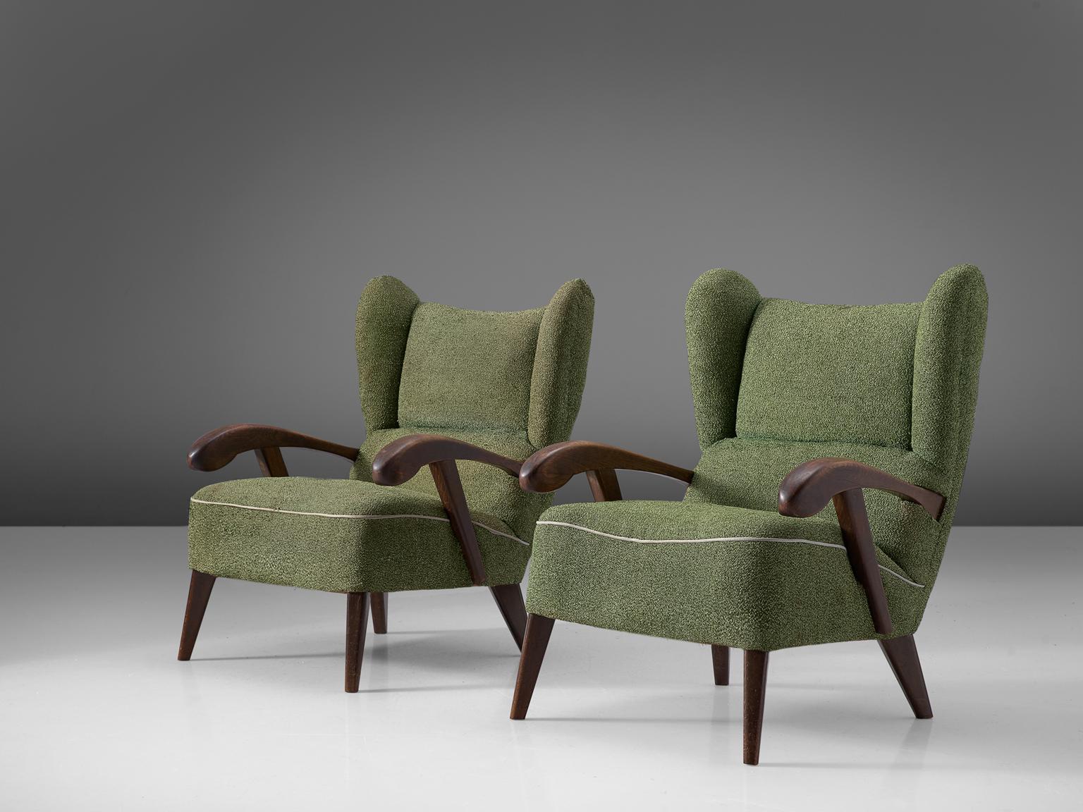 Set of two lounge chairs, in stained beech and green fabric, Czech Republic, 1950s. 

Elegant pair of two wingback chairs with solid beech frame. The grain of the stained wood is nicely visible, especially on the wide sculpted armrests. The wooden