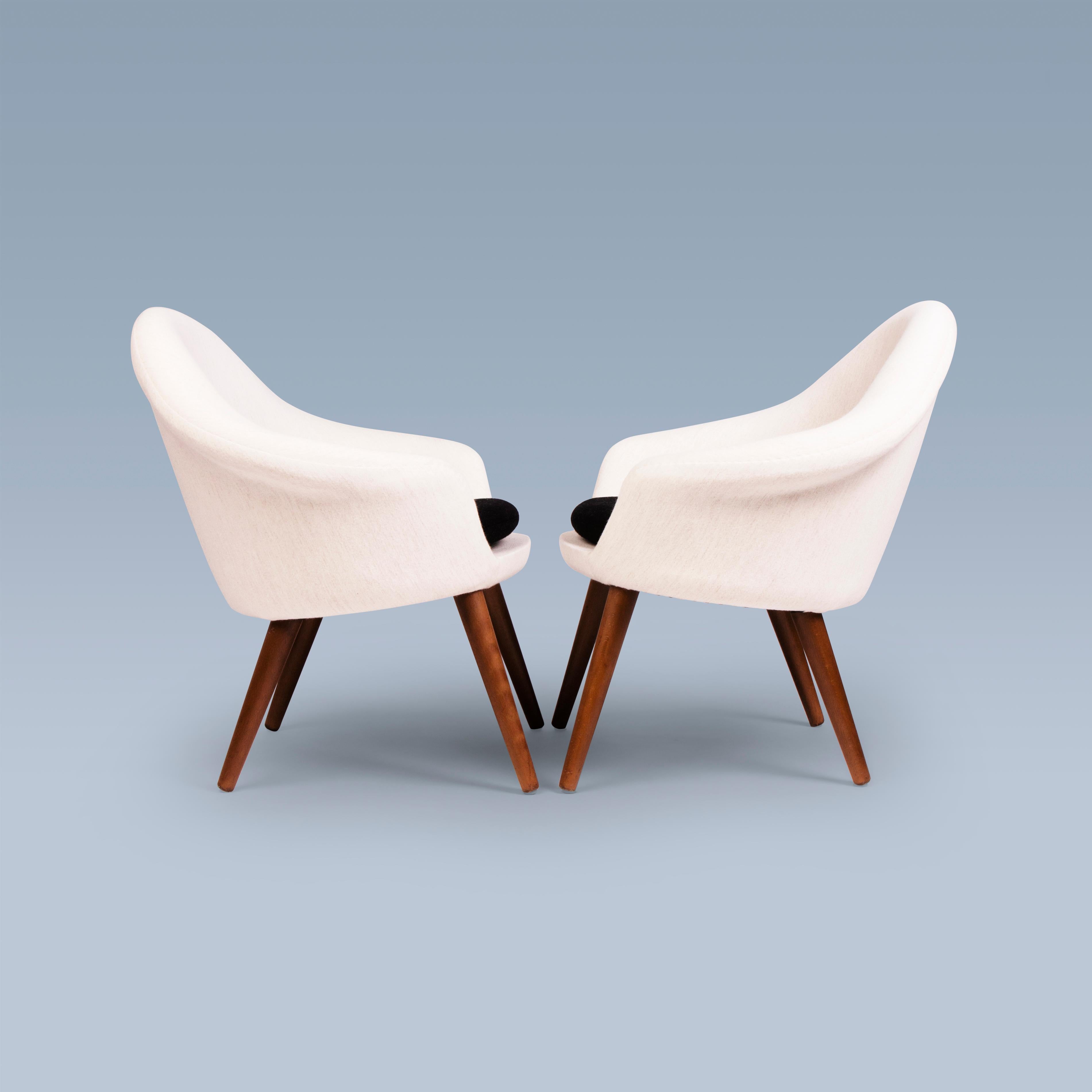 This pair of  lounge chairs with seat cushions were designed in 1956 by Hans Olsen (1919-1992). The chairs have model number 187. They are upholstered with white and black Savak wool by Gabriel. Their legs are of stained wood.
The lounge chairs are
