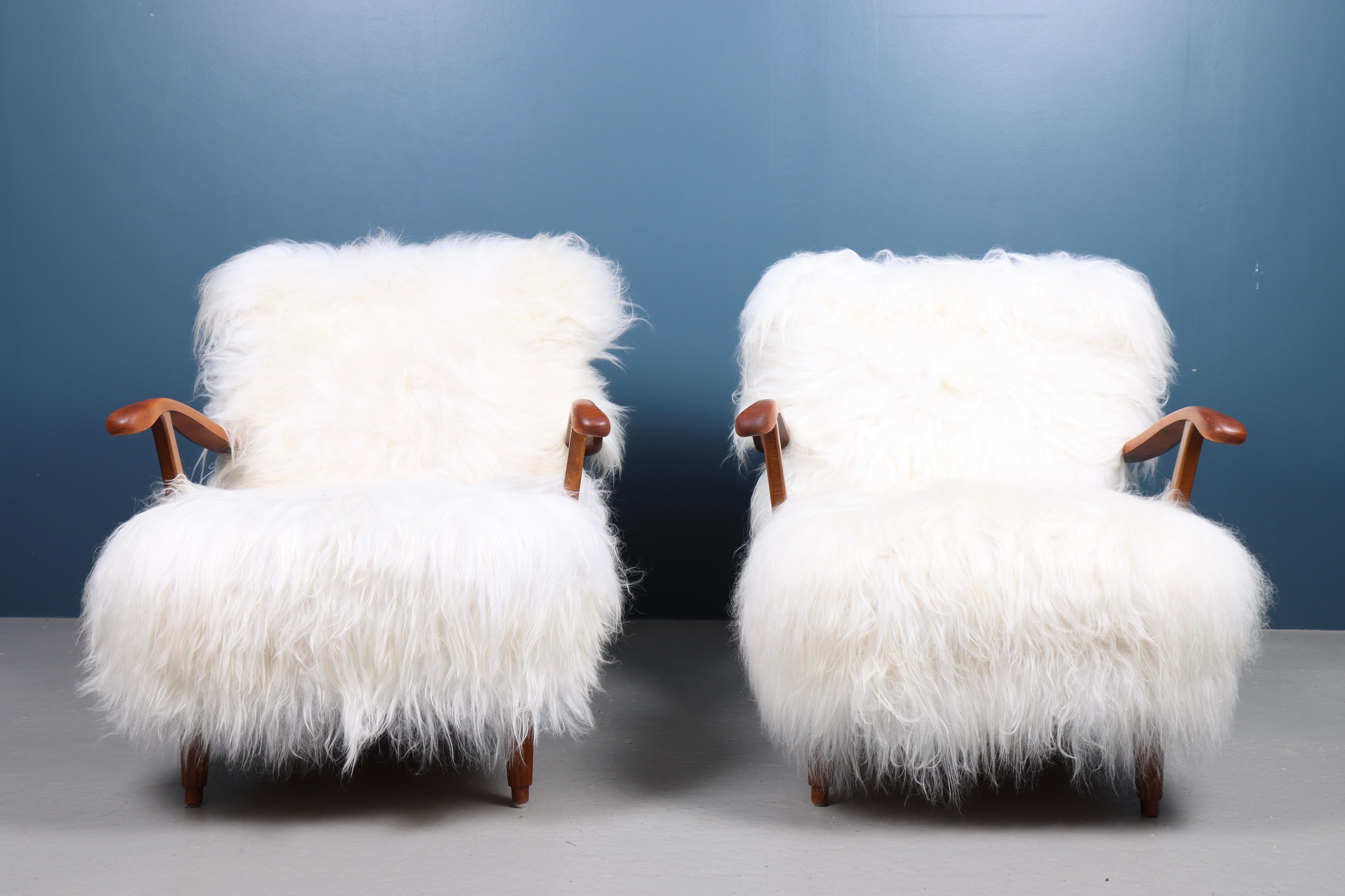 Pair of lounge chairs upholstered in sheepskin. Designed by Svante Skogh and made by Förenade Linköping Möbler 1950s. Great condition.