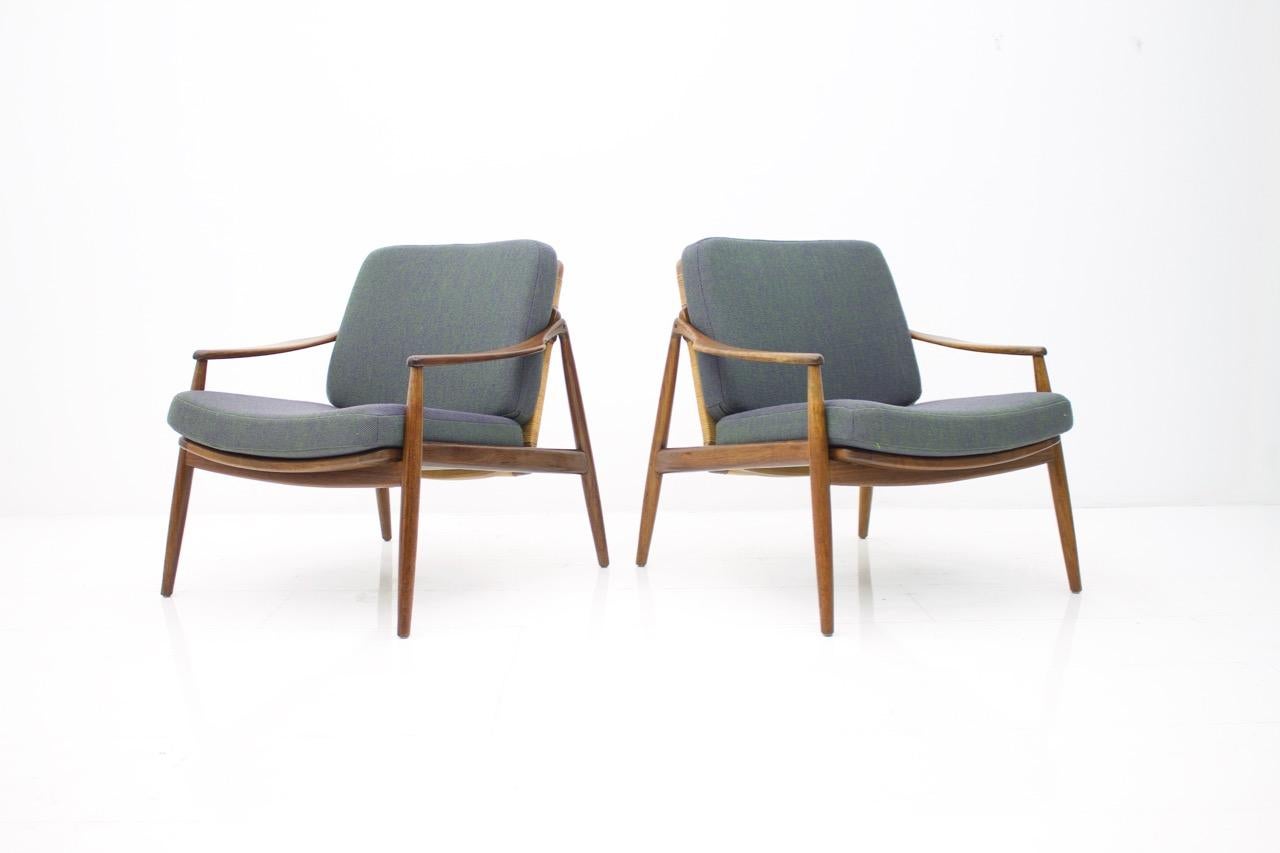 Pair of lounge chairs by Hartmut Lohmeyer by Wilkhahn, Germany, 1956
Teakwood, cane and Kvadrat fabric cushions.
Measurements in cm: Width 71 cm, depth 75 cm, height 73 cm, seating height 40 cm. 

Very good condition!
