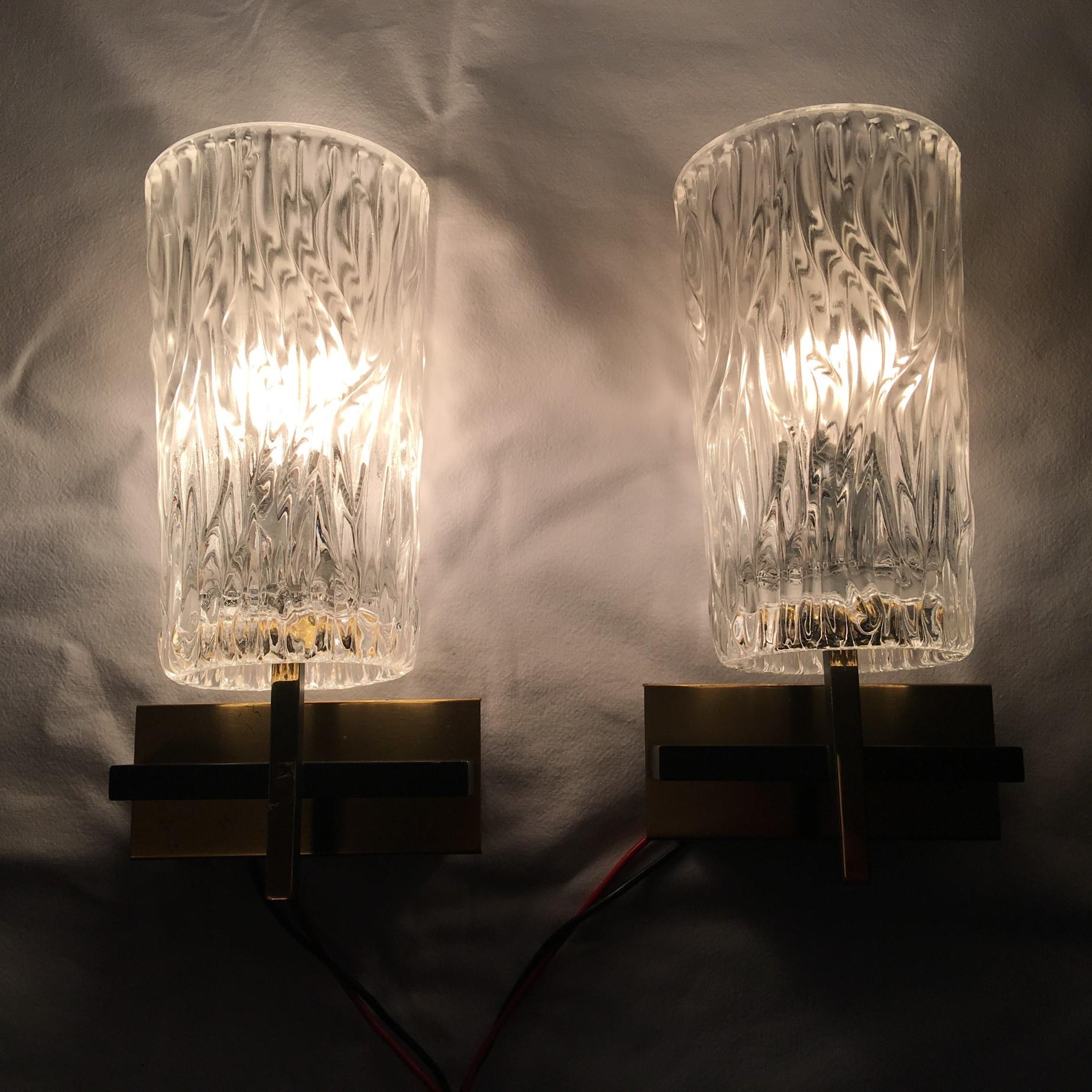 A pair of glass covered Kalmar style sconces. Made of glass, iron and tin. Newly wired to conform to US standards. 3.5/8 '' by 1.7/8 inch wall attachment cover. Each one requires a European E 14 Candelabra bulb up to 40 Watts. Very nice set from the