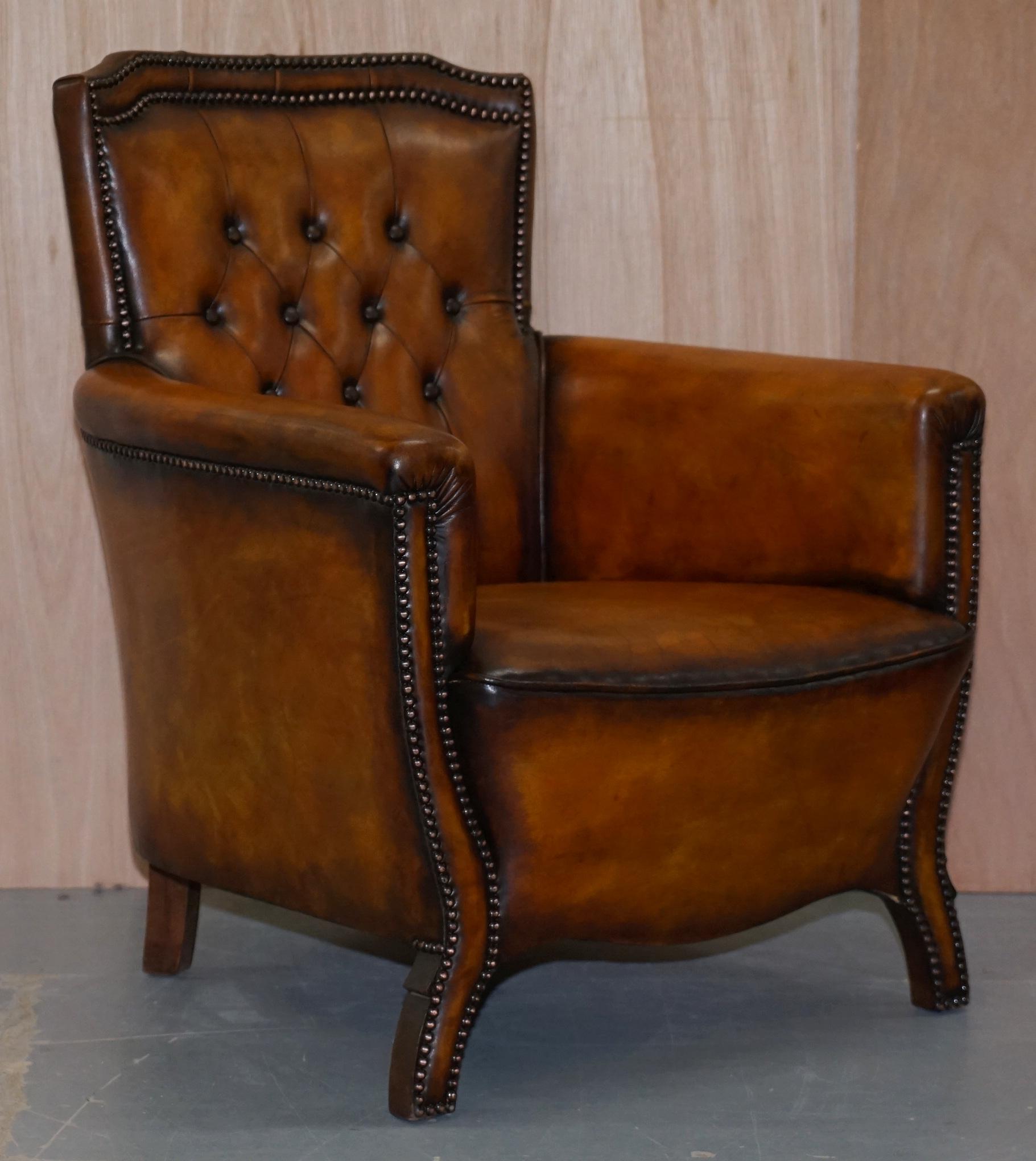 We are delighted to offer for sale this stunning pair of original fully restored Chesterfield Club armchairs with hand dyed whisky brown leather upholstery

A very rare and desirable pair of exceptionally comfortable and decorative armchairs. The