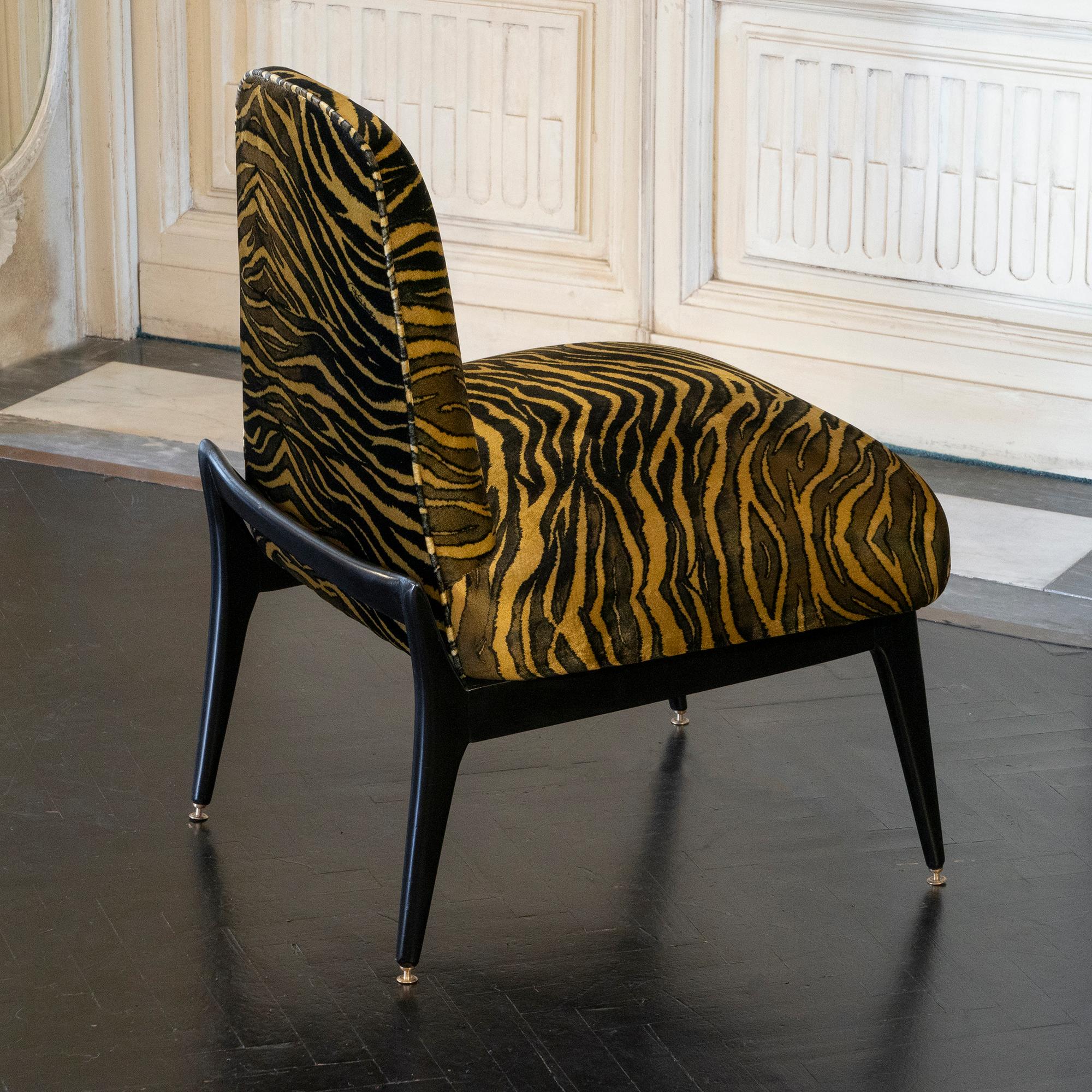 Pair of low lounge chairs, ebonized mahogany base and newly reupholstered with tiger print brown/black and gold silk velvet, brass details, Italy 1950s.