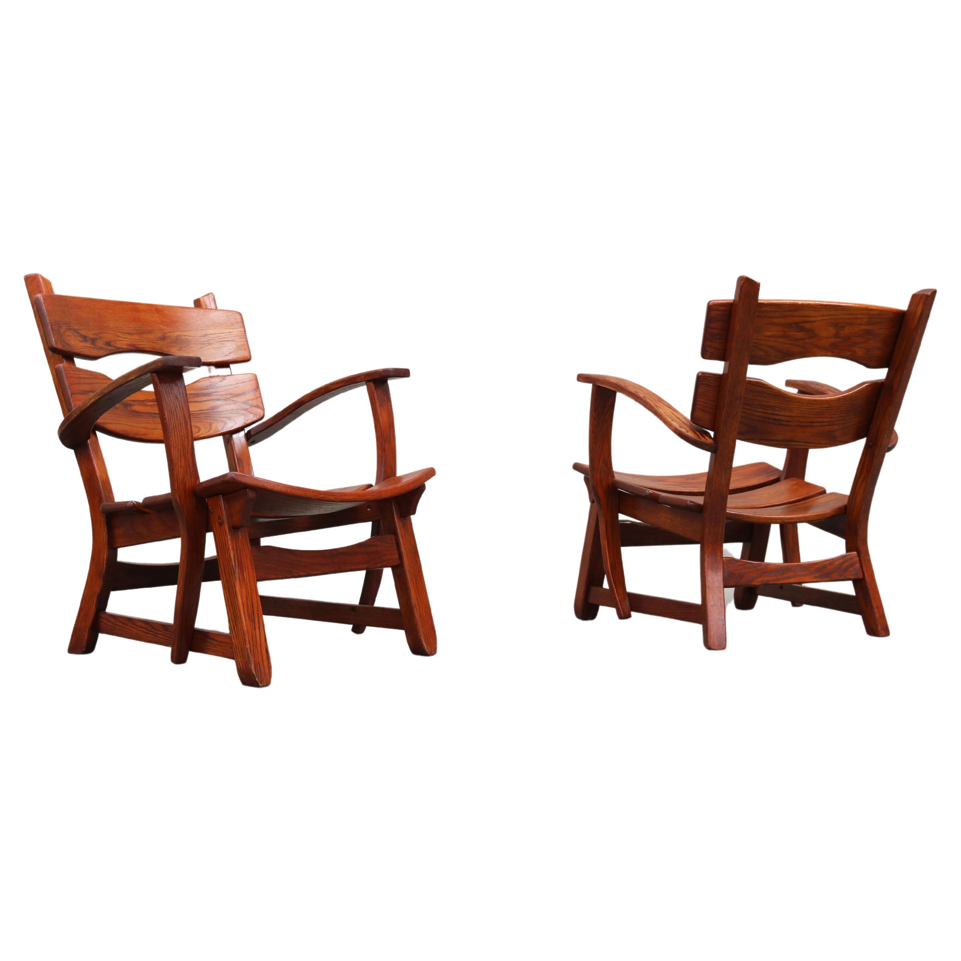 Pair of low Mid-century Design Brutalist lounge chairs / arm chairs in solid oak