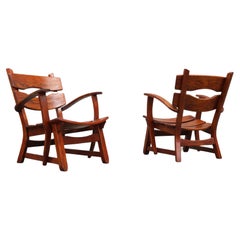 Pair of low Mid-century Design Brutalist lounge chairs / arm chairs in solid oak