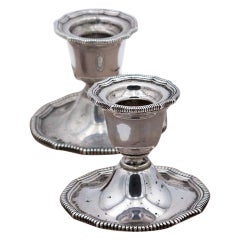 Pair of low silver candlesticks with pearlescent reliefs on the edges and bases