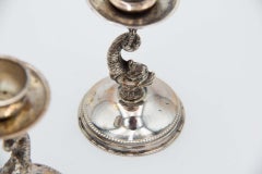 Pair of low silver fish-shaped candlesticks