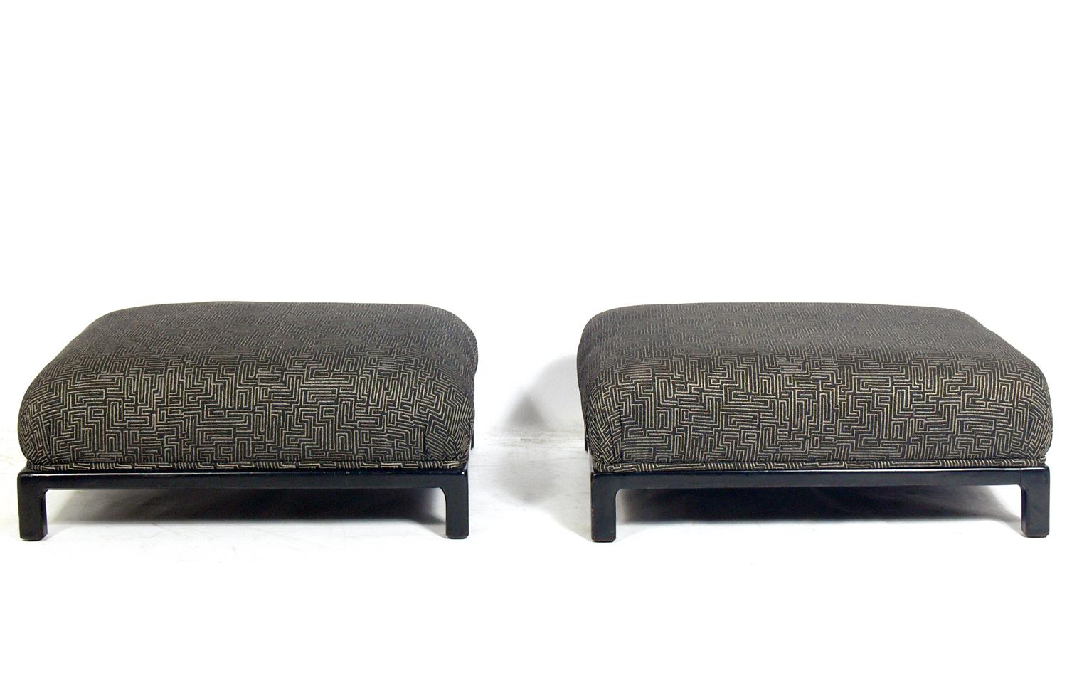Low slung Asian inspired midcentury stools, American, circa 1950s. These pieces were probably reupholstered in their Asian style geometric fabric within the past few years. Black lacquered bases appears to be the original finish.