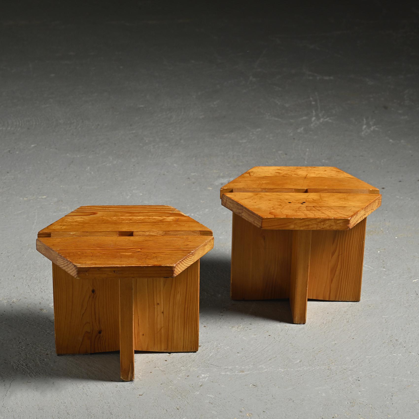 Pair of low stools originating by René Martin, a renowned cabinetmarket who worked for Charlotte Perriand for Les Arcs.  Entirely made of solid pine, with a hexagonal seat mounted on a cross-shaped base.

Their versatile design also allows them to