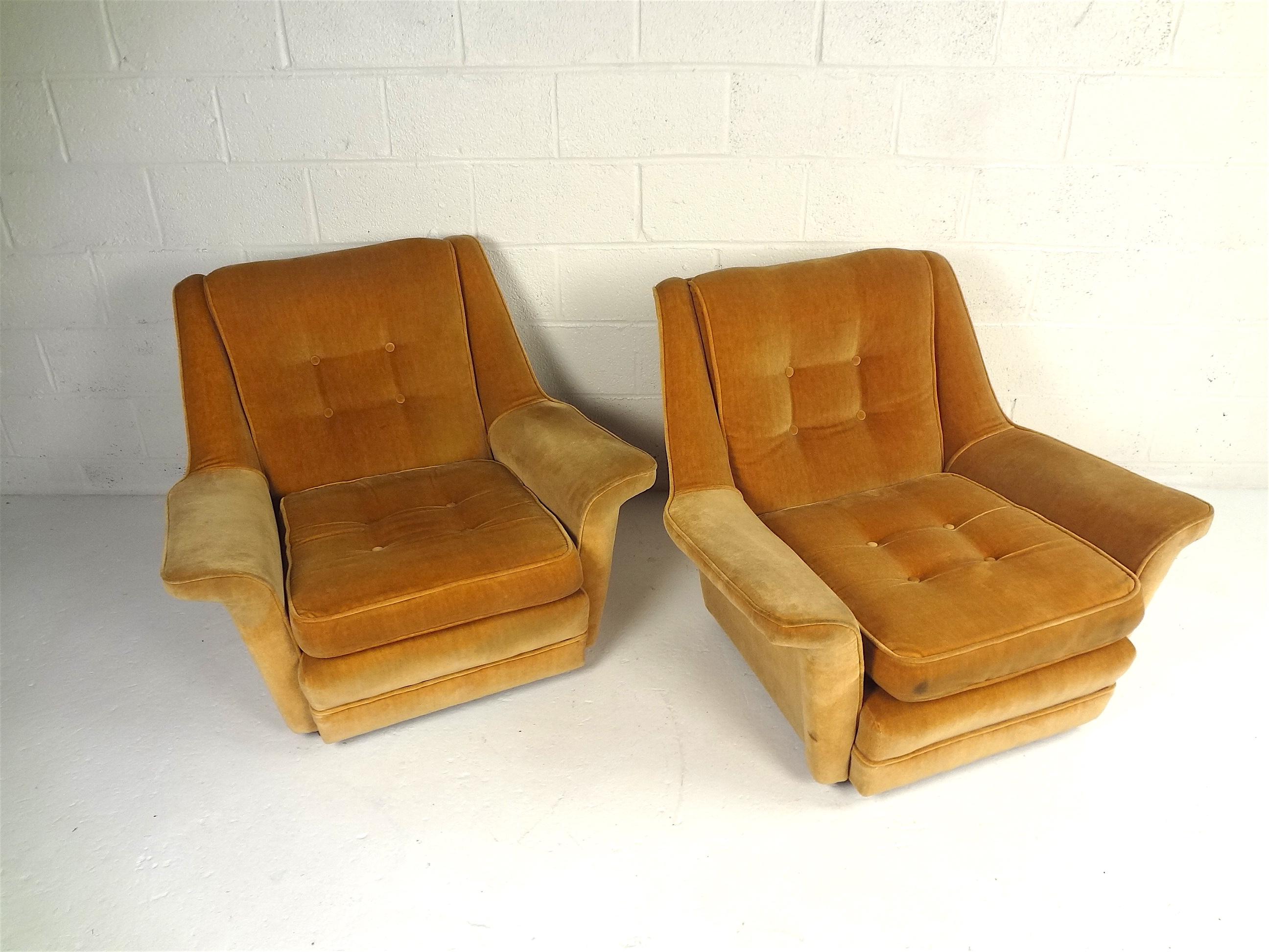 This pair of plush beautifully worn velvet chairs will make a great addition to any family or living room. They are gently worn from age, and as a result, allow you to almost sink into them at the end of a long day. Extremely comfortable. This set